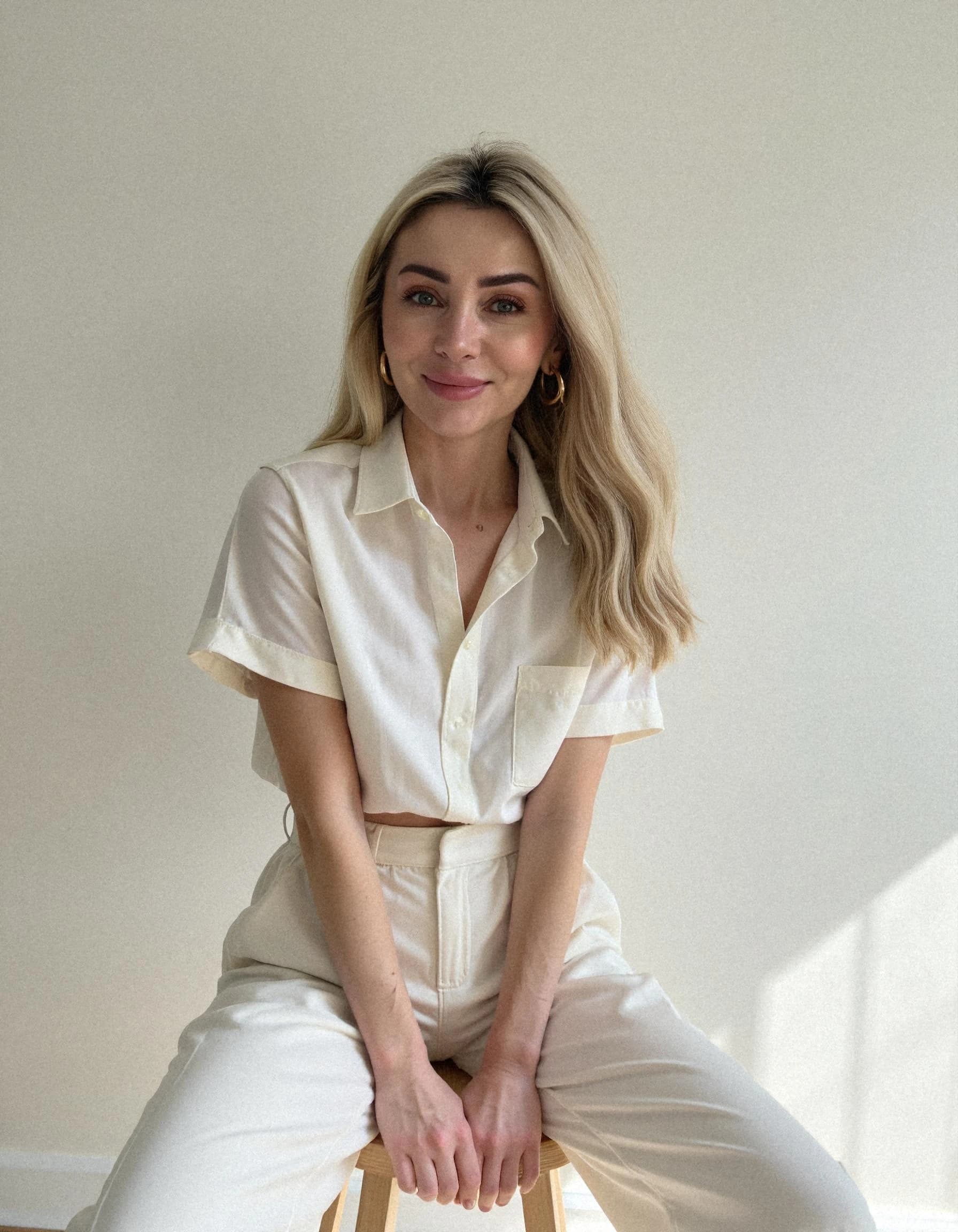 Professional headshot example: Woman Indoor White Outfit Sitting — LinkedInHeadshots.ai