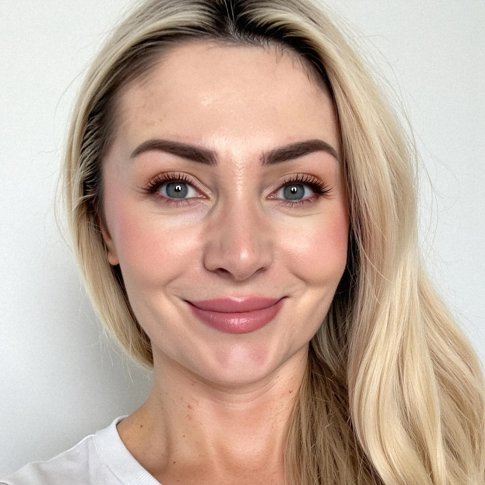 Professional headshot example: Woman Indoor White Top Smiling Headshot — LinkedInHeadshots.ai