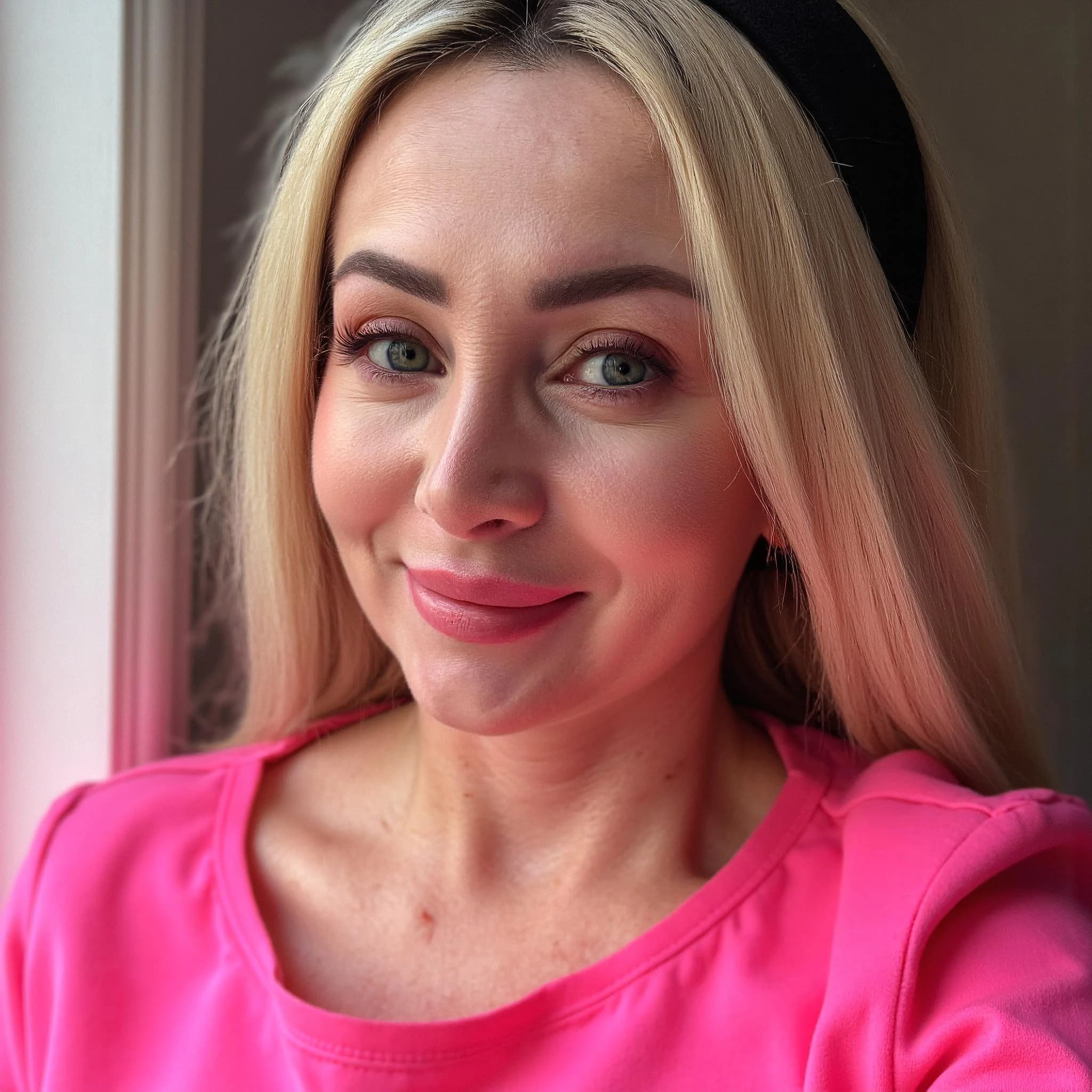 Professional headshot example: Woman Indoors Pink Top Smiling — LinkedInHeadshots.ai