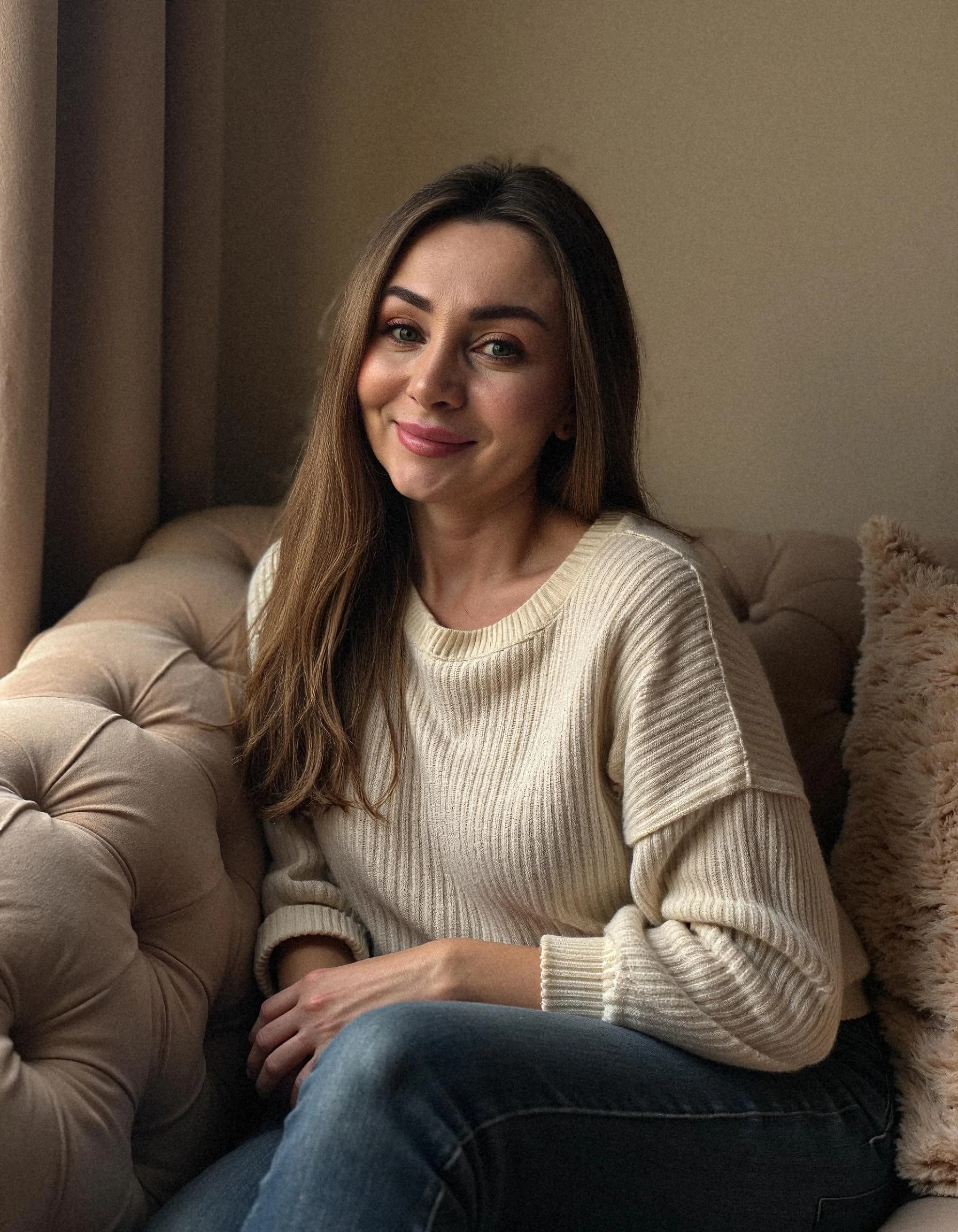 Professional headshot example: Woman Livingroom White Sweater Smiling — LinkedInHeadshots.ai