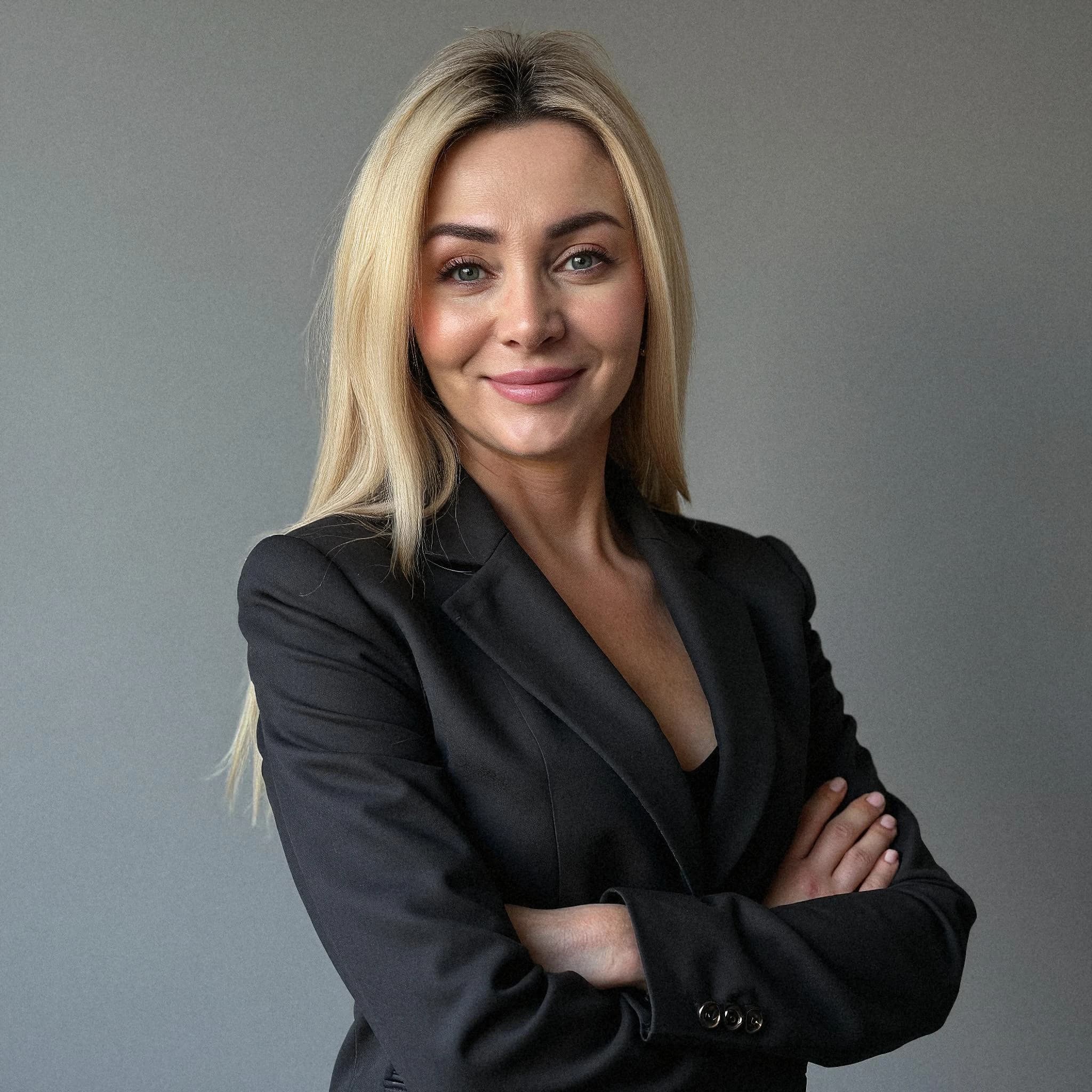 Professional headshot example: Woman Office Black Blazer Crossed Arms — LinkedInHeadshots.ai