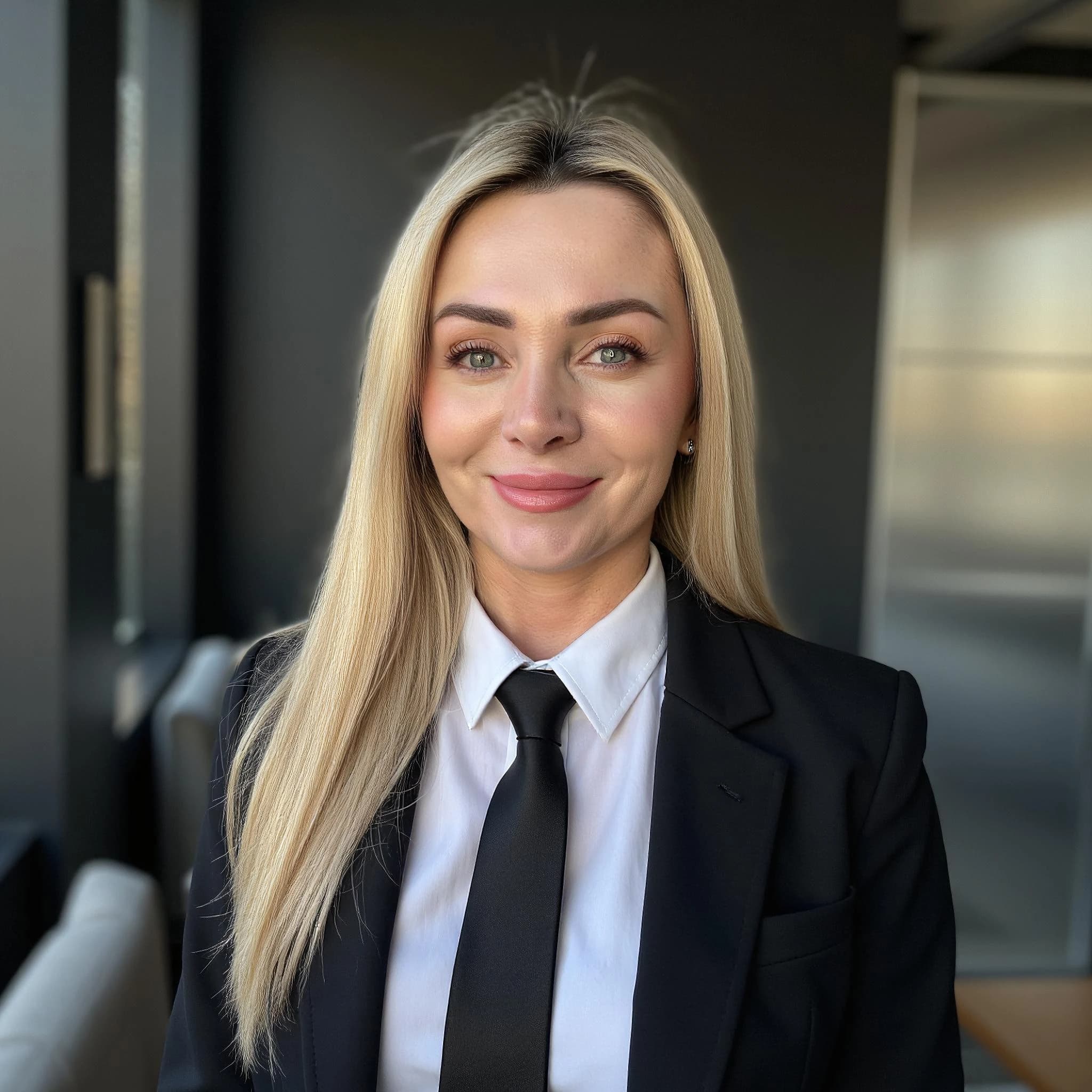 Professional headshot example: Woman Office Black Suit Smiling — LinkedInHeadshots.ai