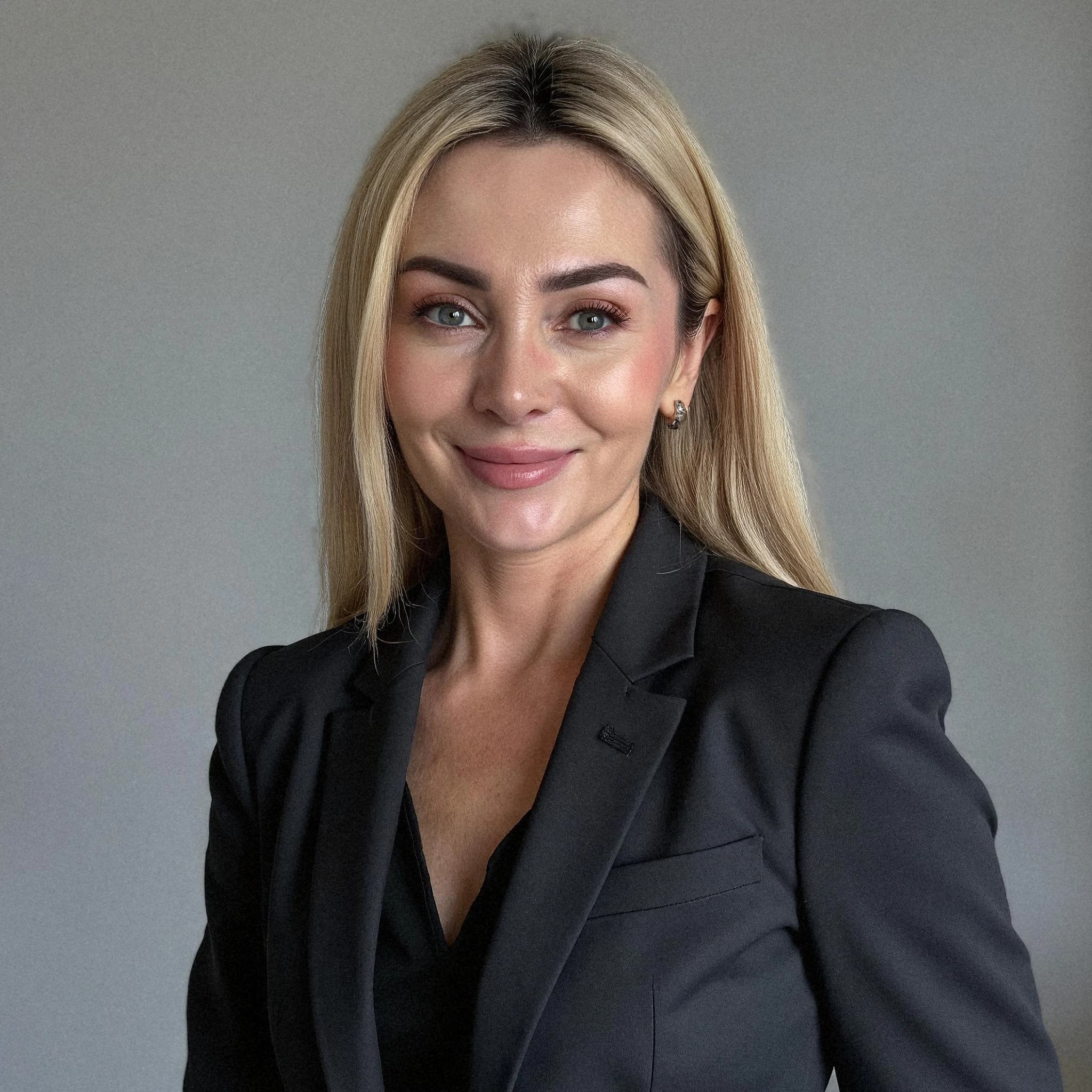 Professional headshot example: Woman Office Black Suit Smiling 15 — LinkedInHeadshots.ai