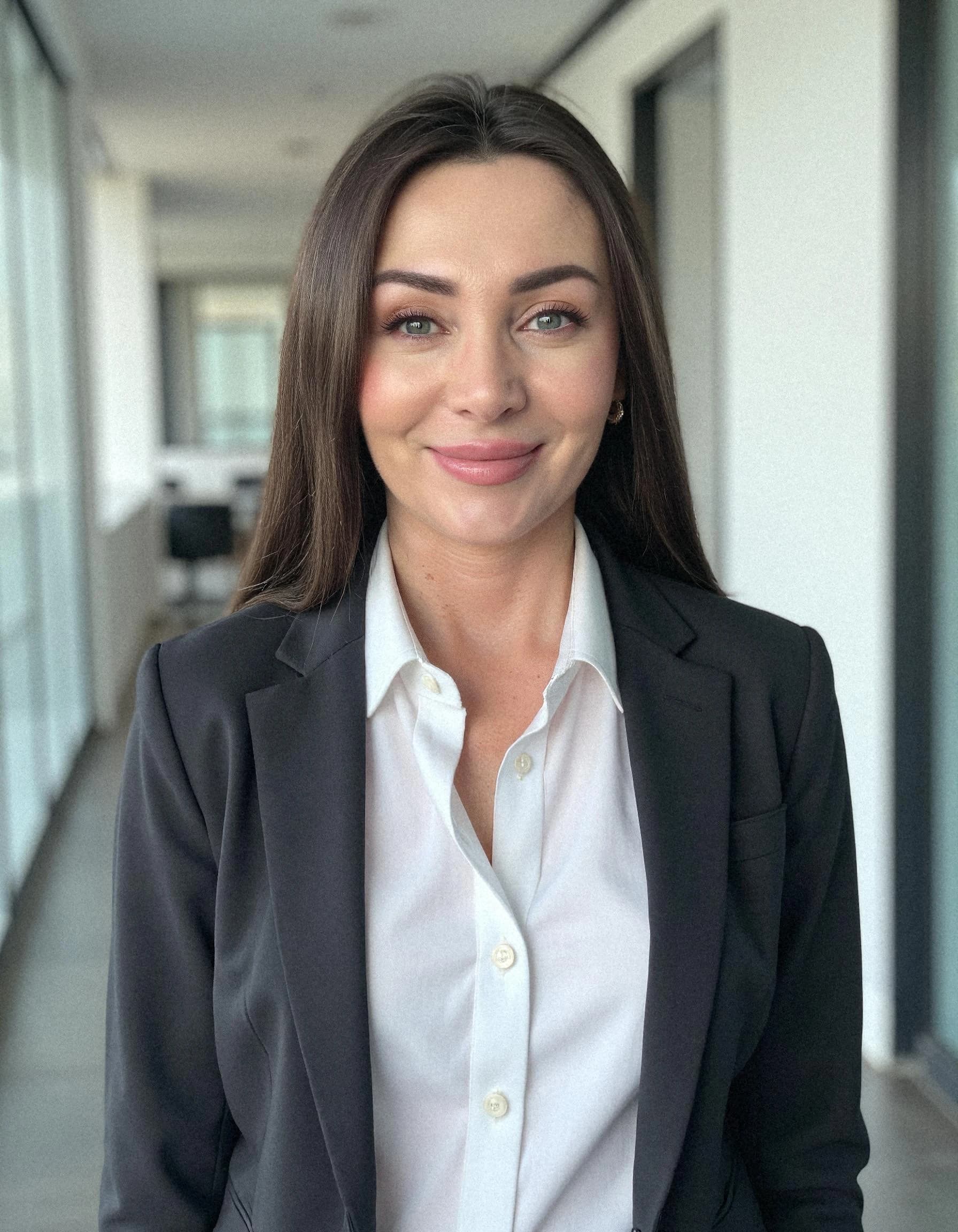 Professional headshot example: Woman Office Black Suit Smiling 4 — LinkedInHeadshots.ai