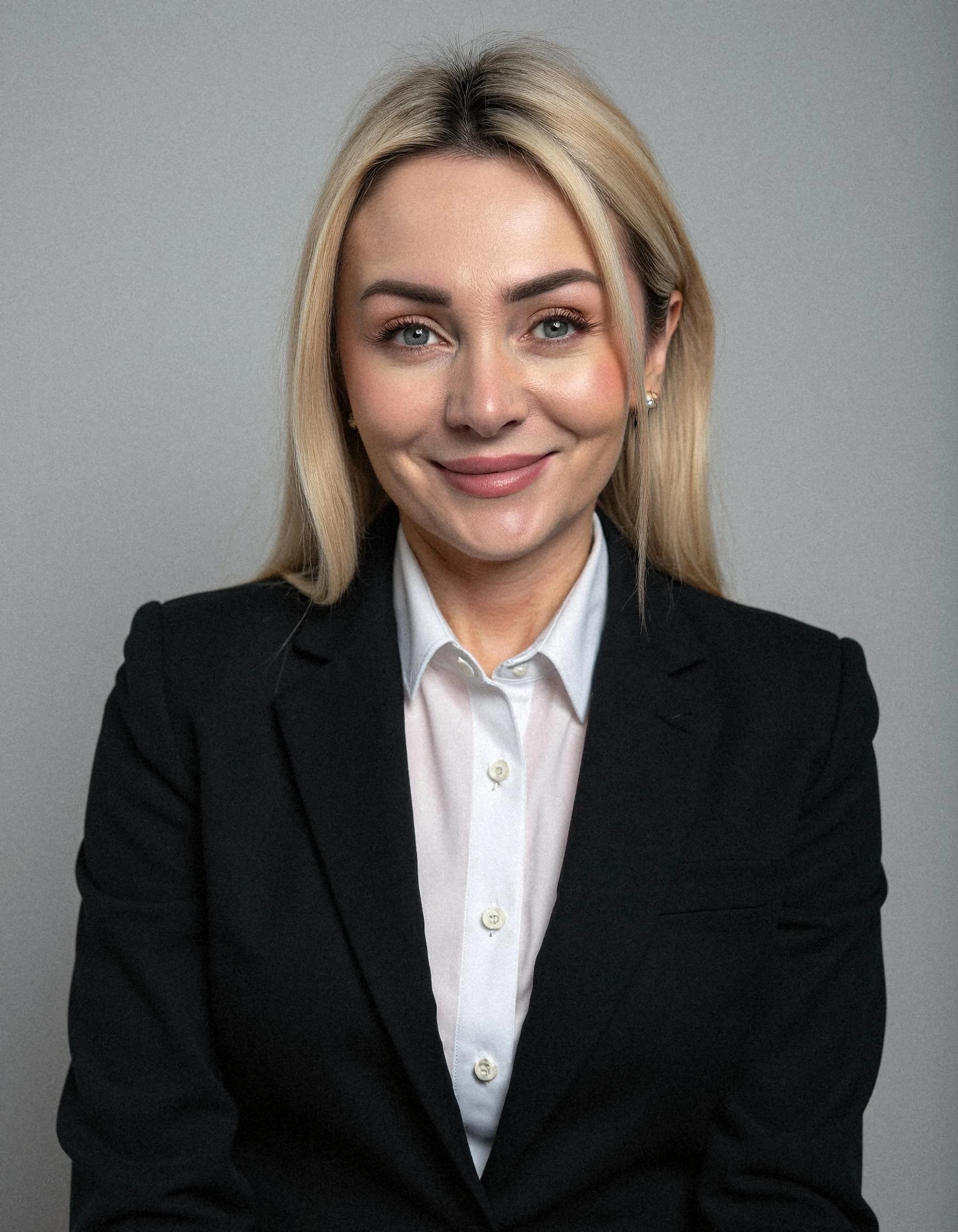 Professional headshot example: Woman Office Black Suit Smiling 6 — LinkedInHeadshots.ai