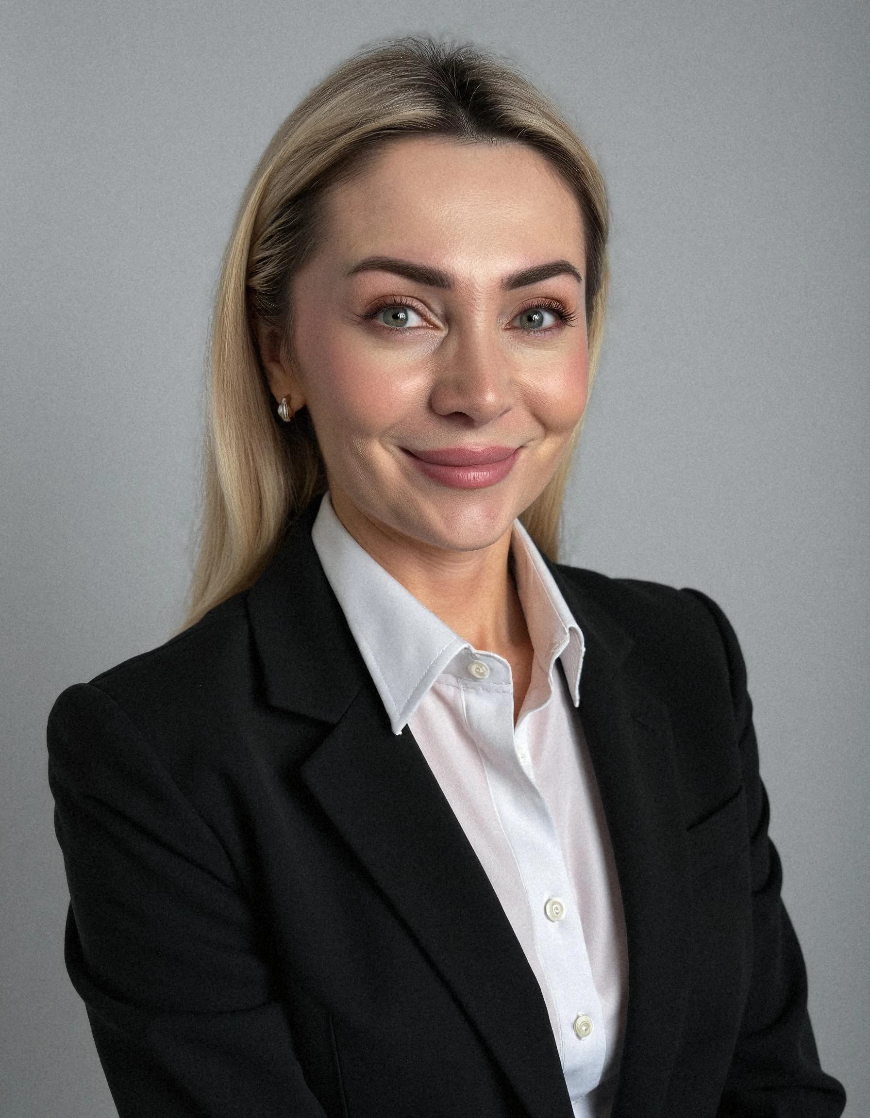 Professional headshot example: Woman Office Black Suit Smiling 8 — LinkedInHeadshots.ai