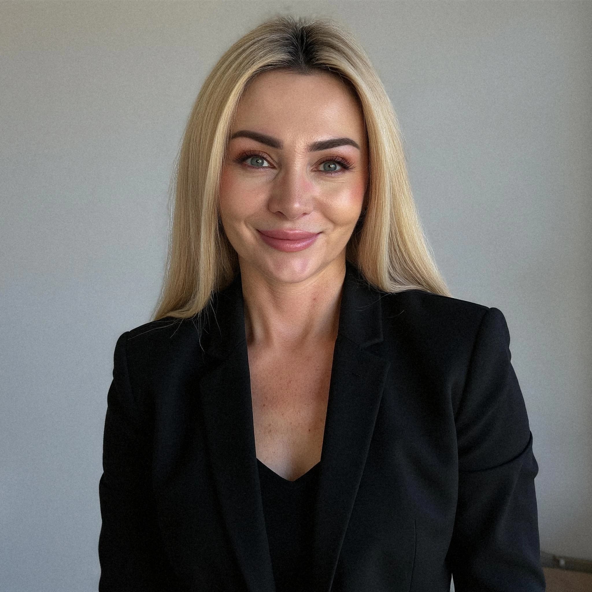 Professional headshot example: Woman Office Black Suit Smiling 9 — LinkedInHeadshots.ai