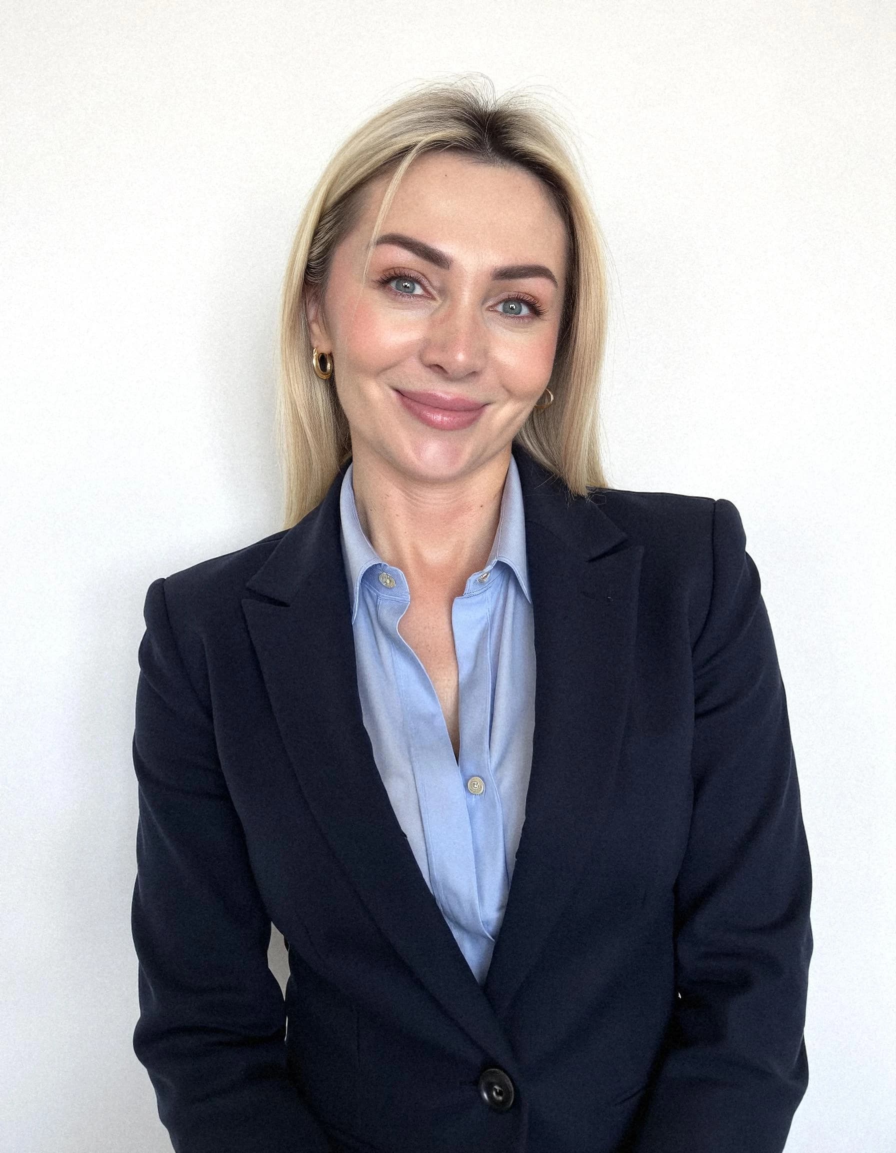 Professional headshot example: Woman Office Blue Shirt Smiling 5 — LinkedInHeadshots.ai