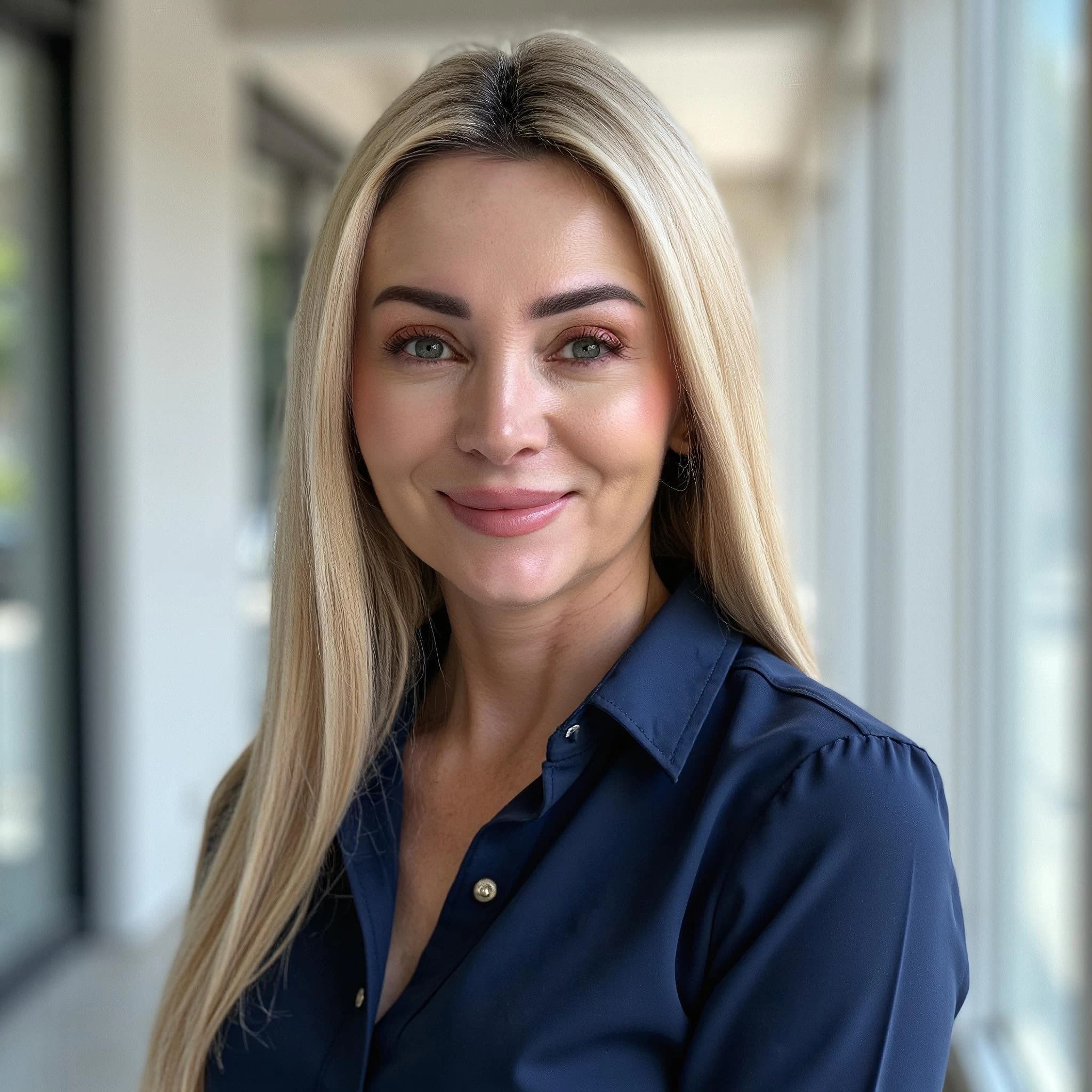 Professional headshot example: Woman Office Blue Shirt Smiling 6 — LinkedInHeadshots.ai