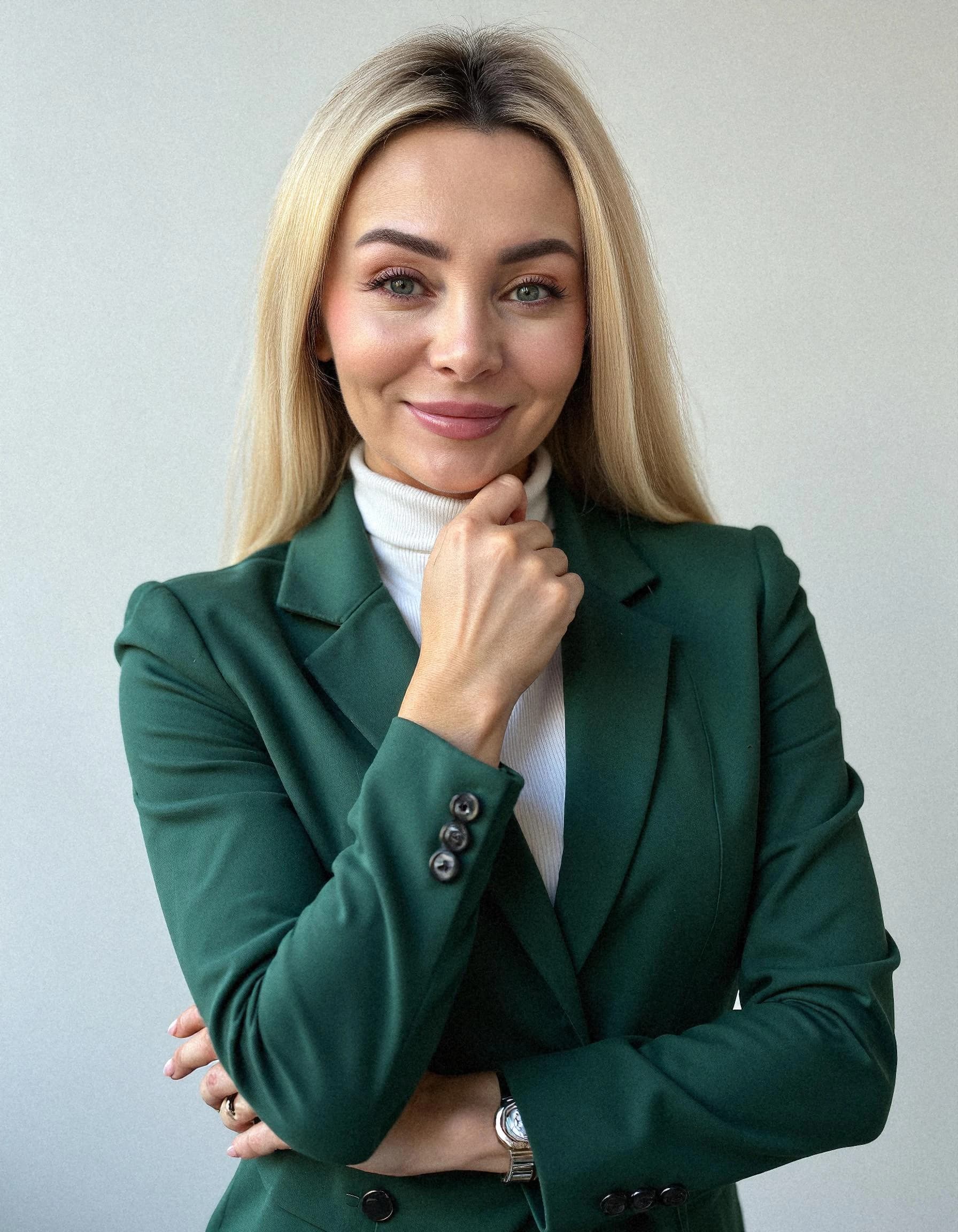 Professional headshot example: Woman Office Green Blazer Smiling 2 — LinkedInHeadshots.ai