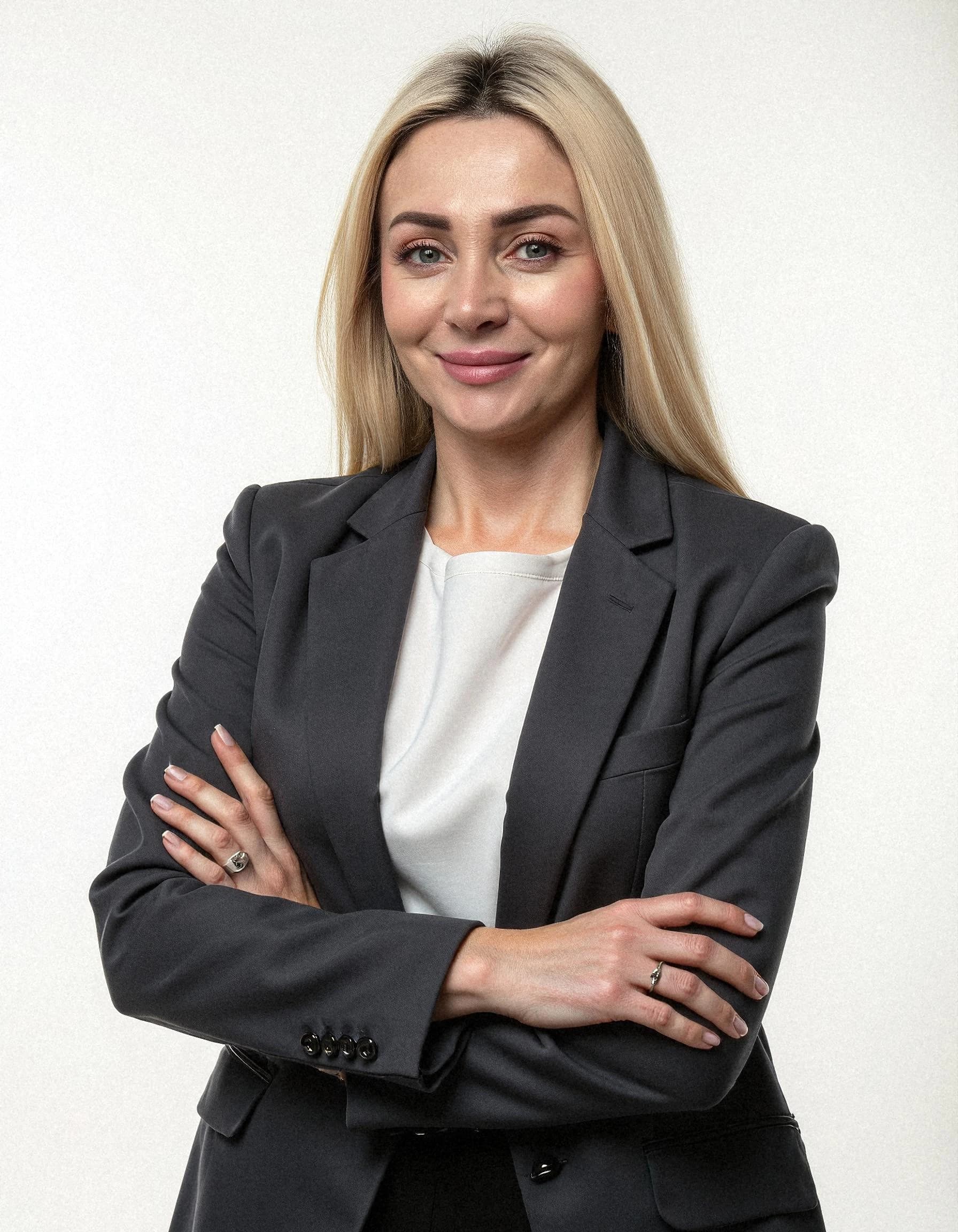 Professional headshot example: Woman Office Suit Crossed Arms — LinkedInHeadshots.ai