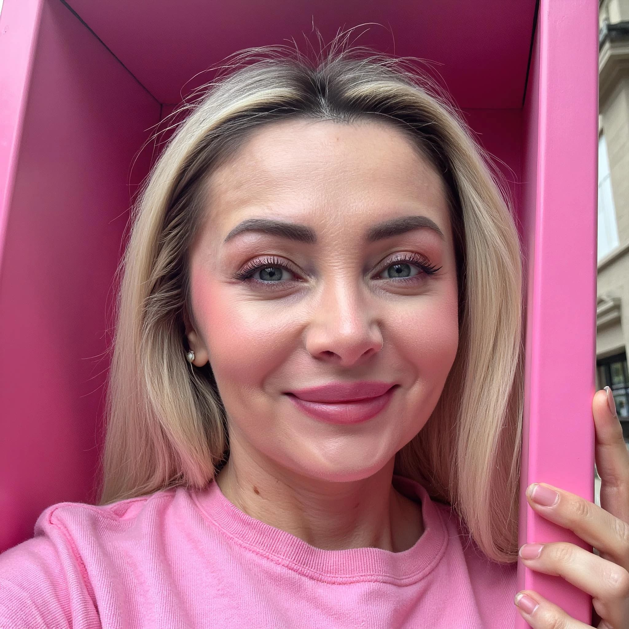 Professional headshot example: Woman Outdoors Pink Shirt Smiling — LinkedInHeadshots.ai