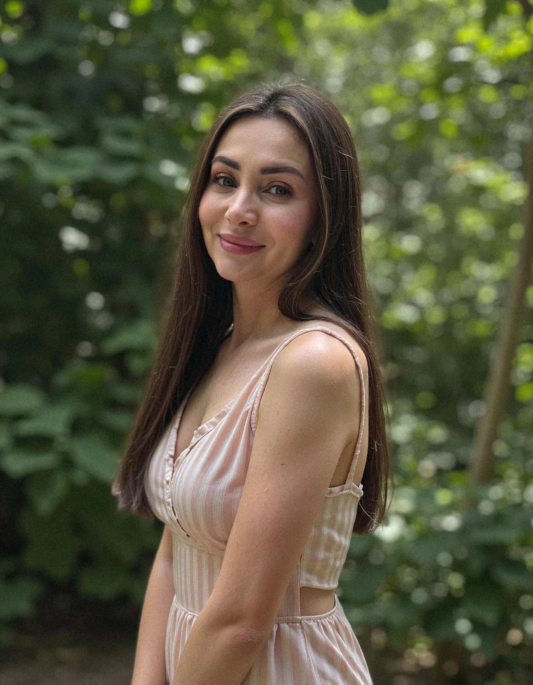 Professional headshot example: Woman Outdoors Striped Dress Smiling — LinkedInHeadshots.ai