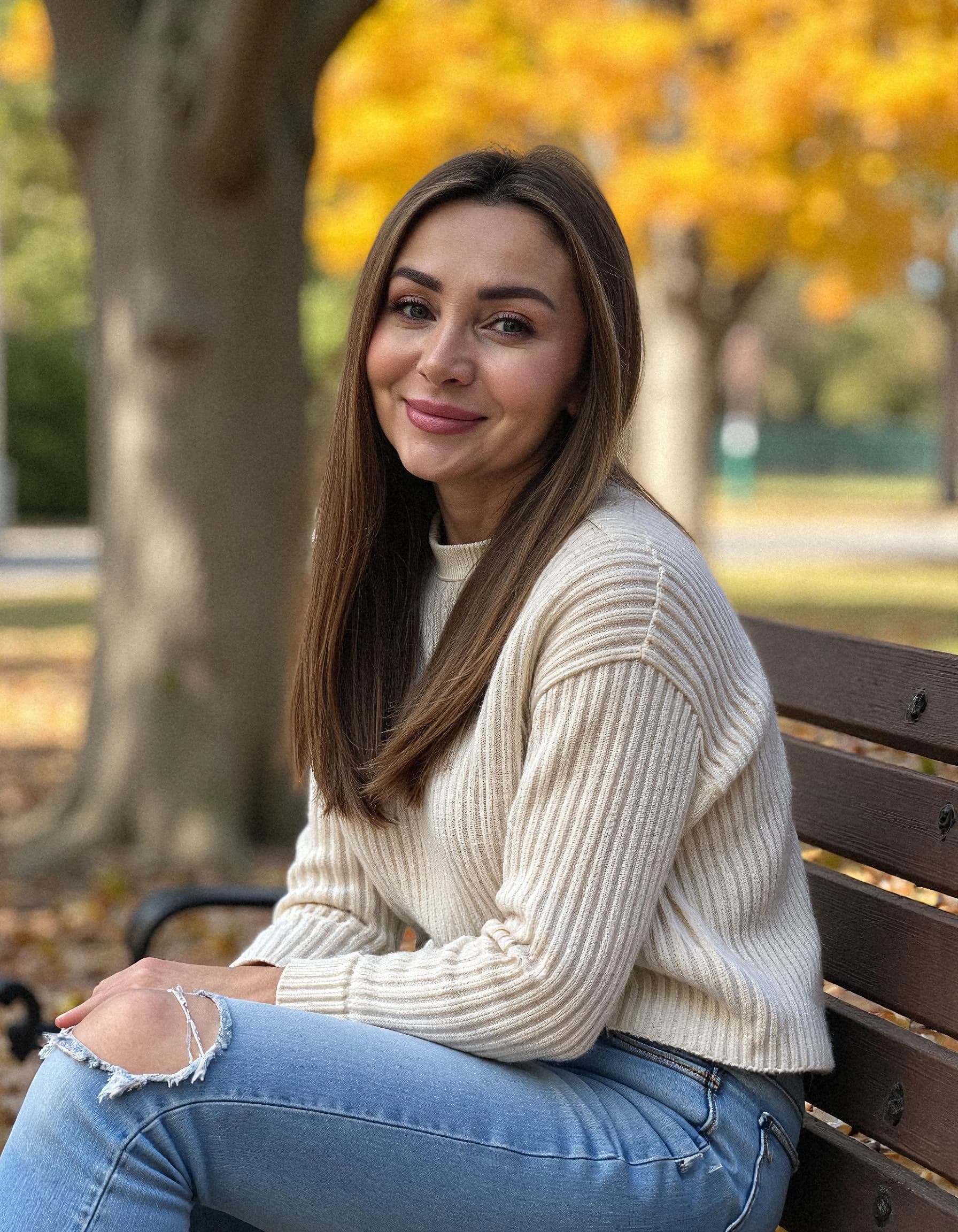 Professional headshot example: Woman Park Cream Sweater Sitting Bench — LinkedInHeadshots.ai