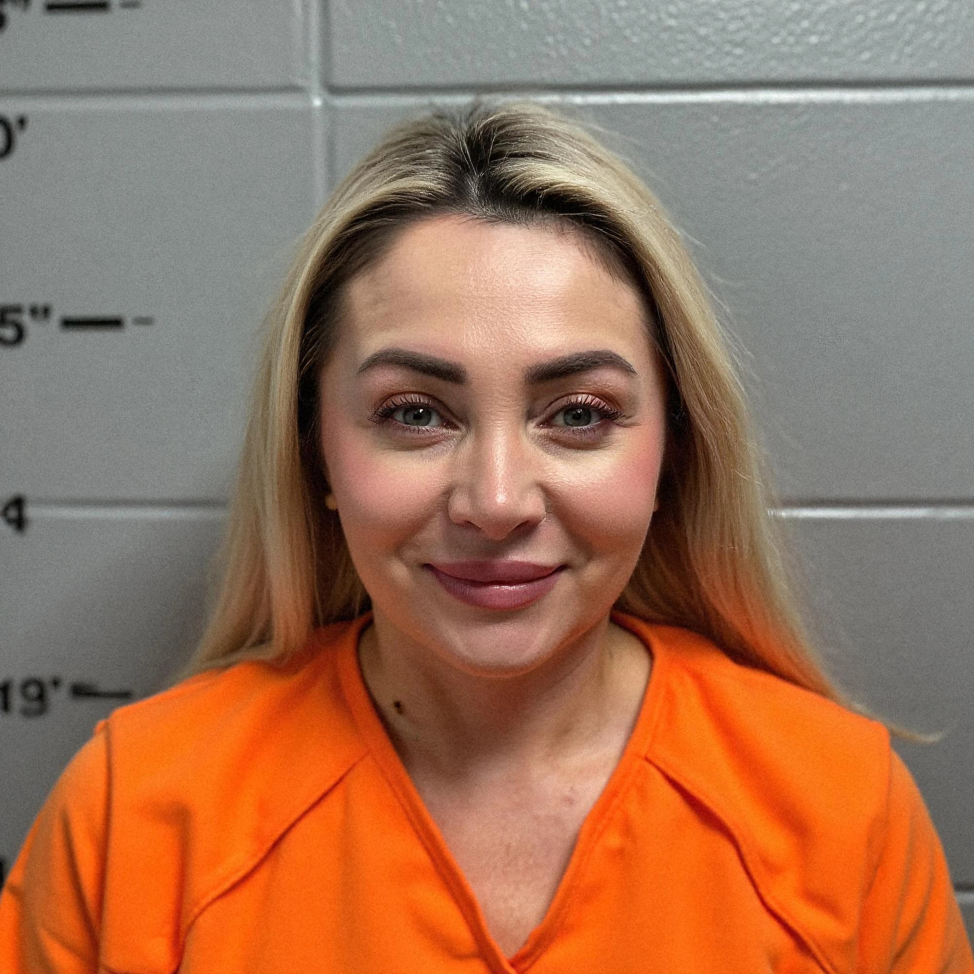 Professional headshot example: Woman Police Station Orange Uniform Smiling 2 — LinkedInHeadshots.ai