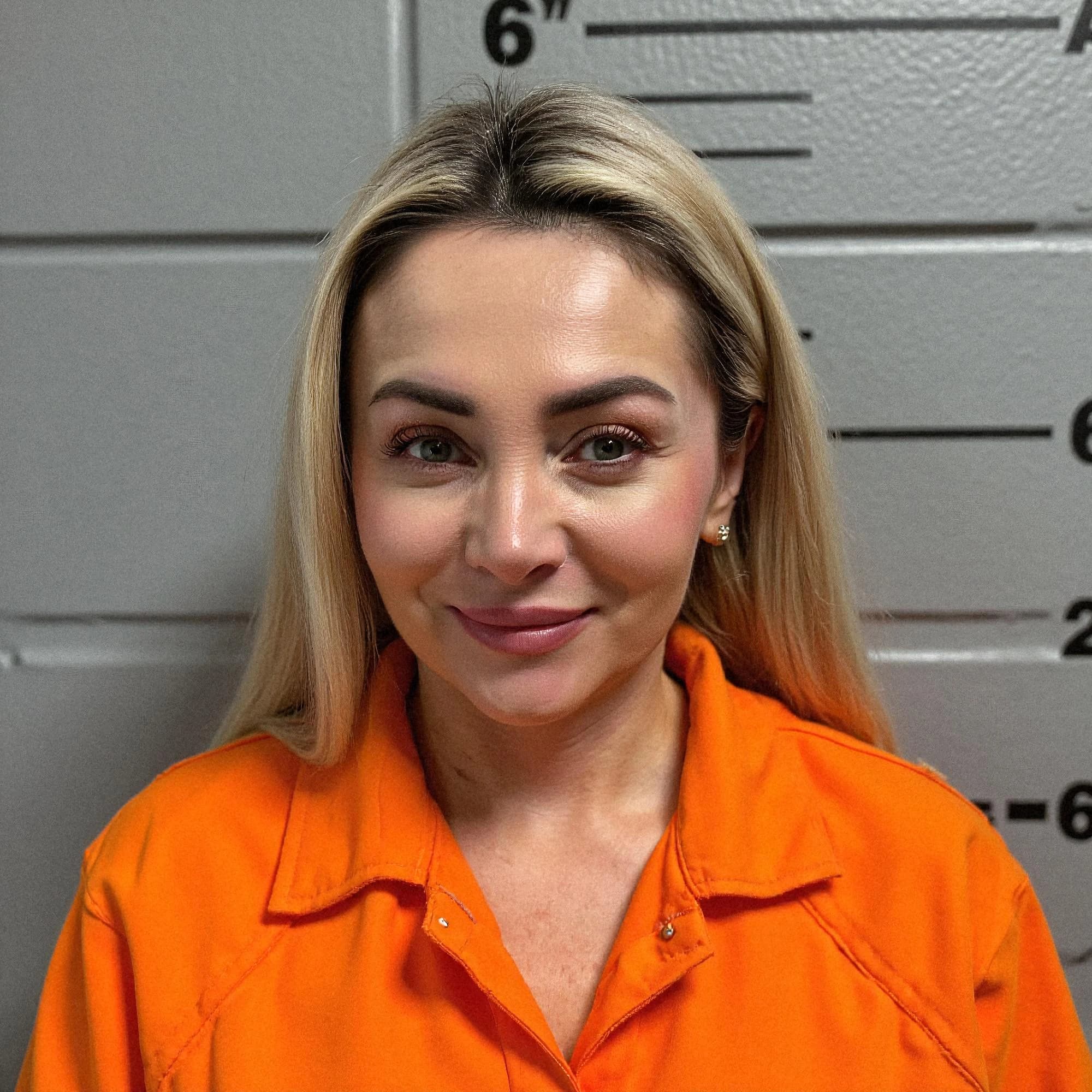 Professional headshot example: Woman Station Orange Uniform Smiling — LinkedInHeadshots.ai