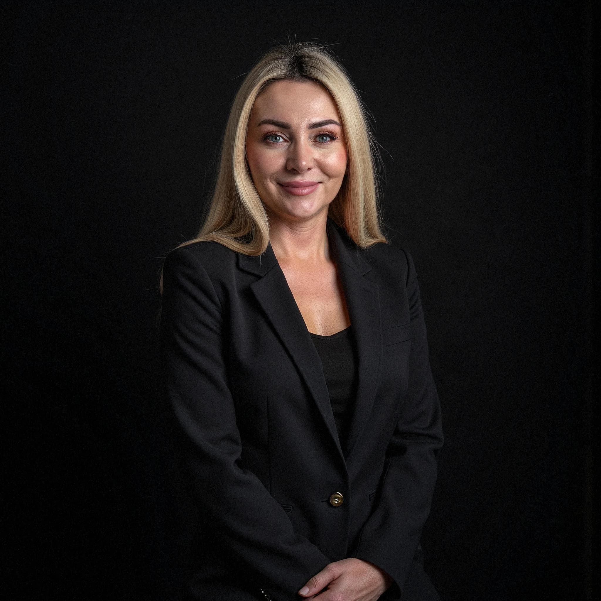 Professional headshot example: Woman Studio Black Blazer Smiling 15 — LinkedInHeadshots.ai