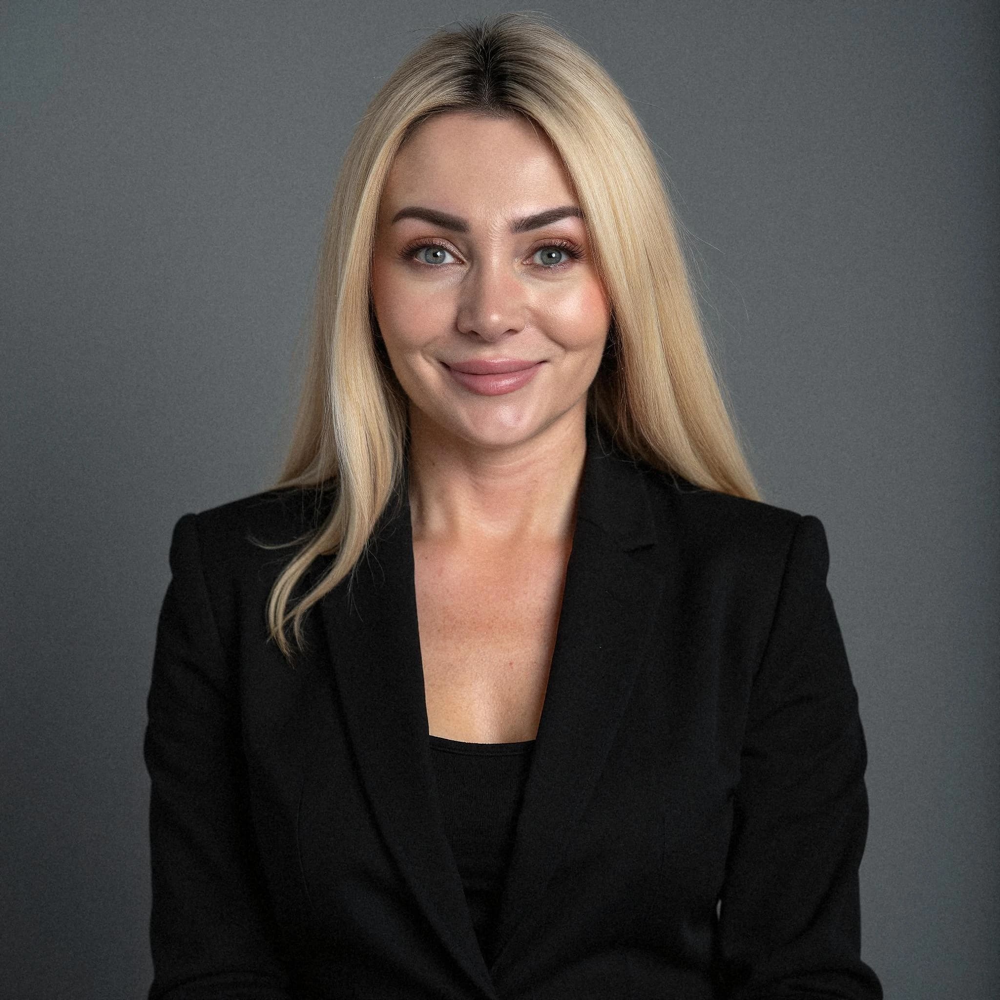 Professional headshot example: Woman Studio Black Blazer Smiling 16 — LinkedInHeadshots.ai
