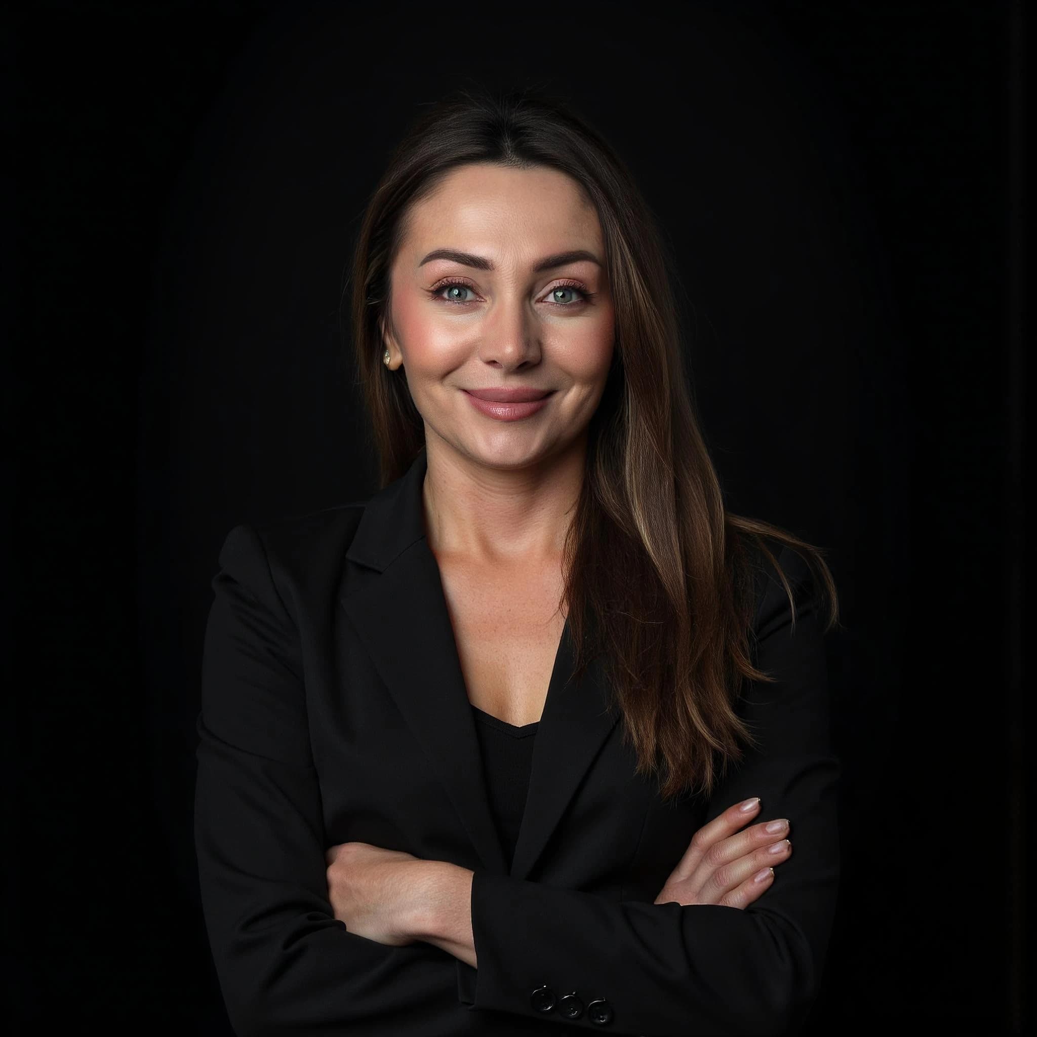 Professional headshot example: Woman Studio Black Suit Crossed Arms 6 — LinkedInHeadshots.ai