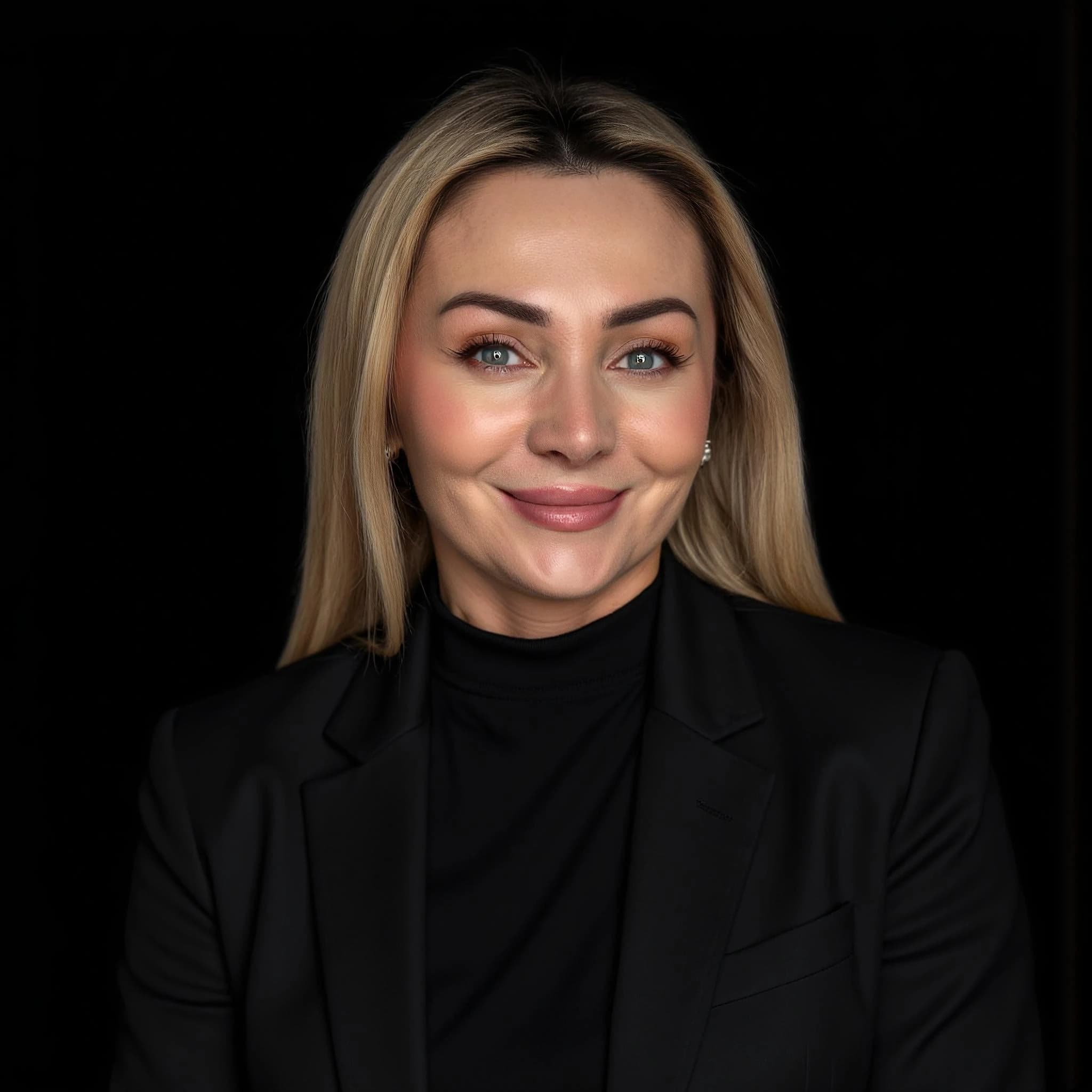 Professional headshot example: Woman Studio Black Suit Smiling — LinkedInHeadshots.ai