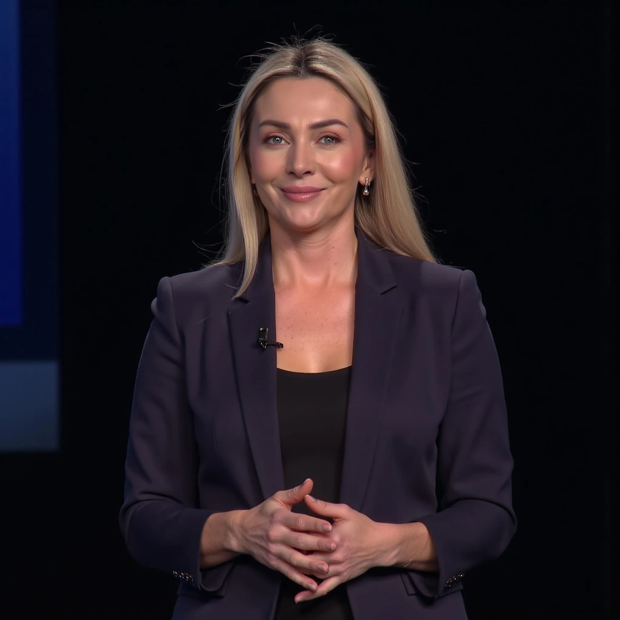 Professional headshot example: Woman Studio Black Suit Smiling 11 — LinkedInHeadshots.ai