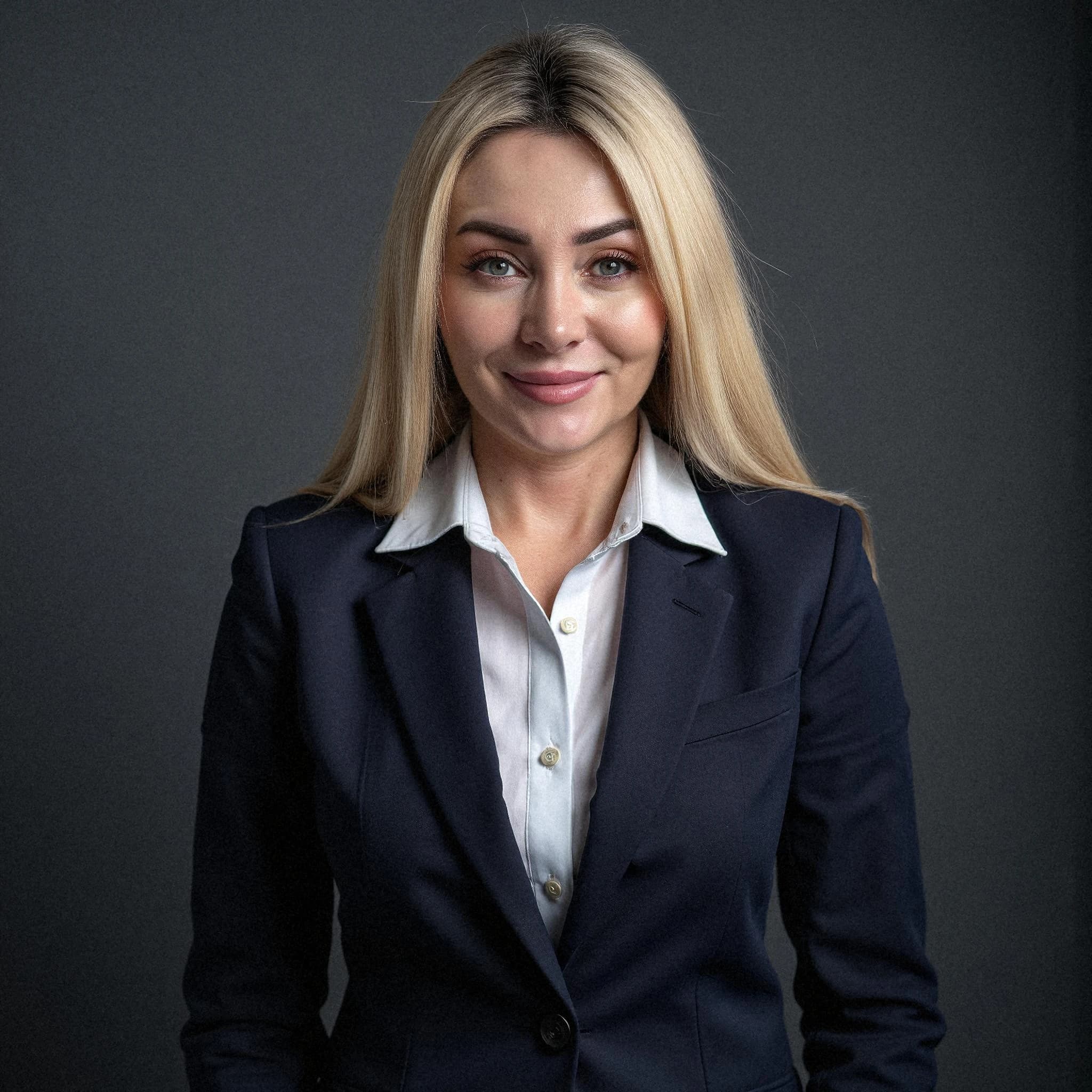 Professional headshot example: Woman Studio Black Suit Smiling 15 — LinkedInHeadshots.ai