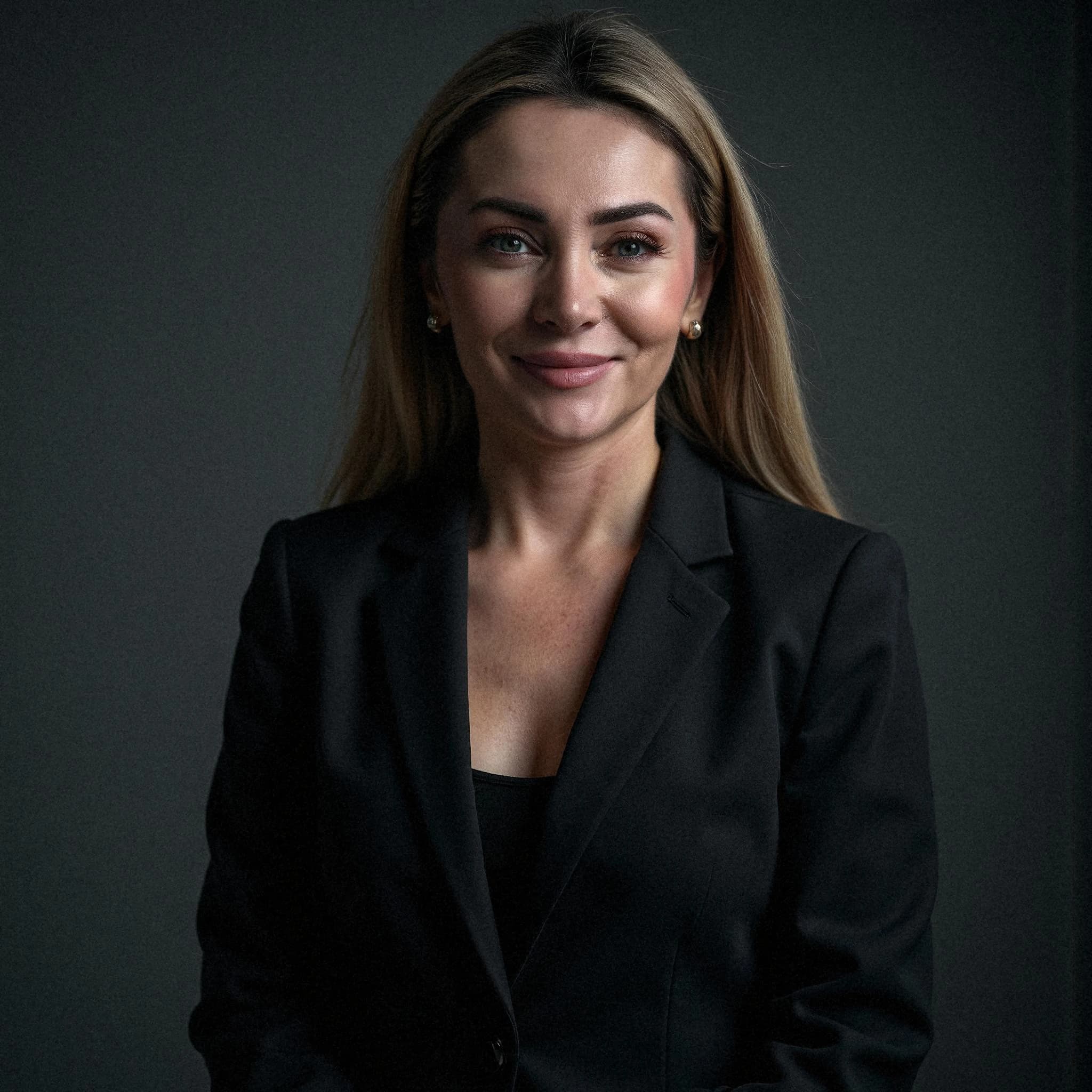 Professional headshot example: Woman Studio Black Suit Smiling 17 — LinkedInHeadshots.ai