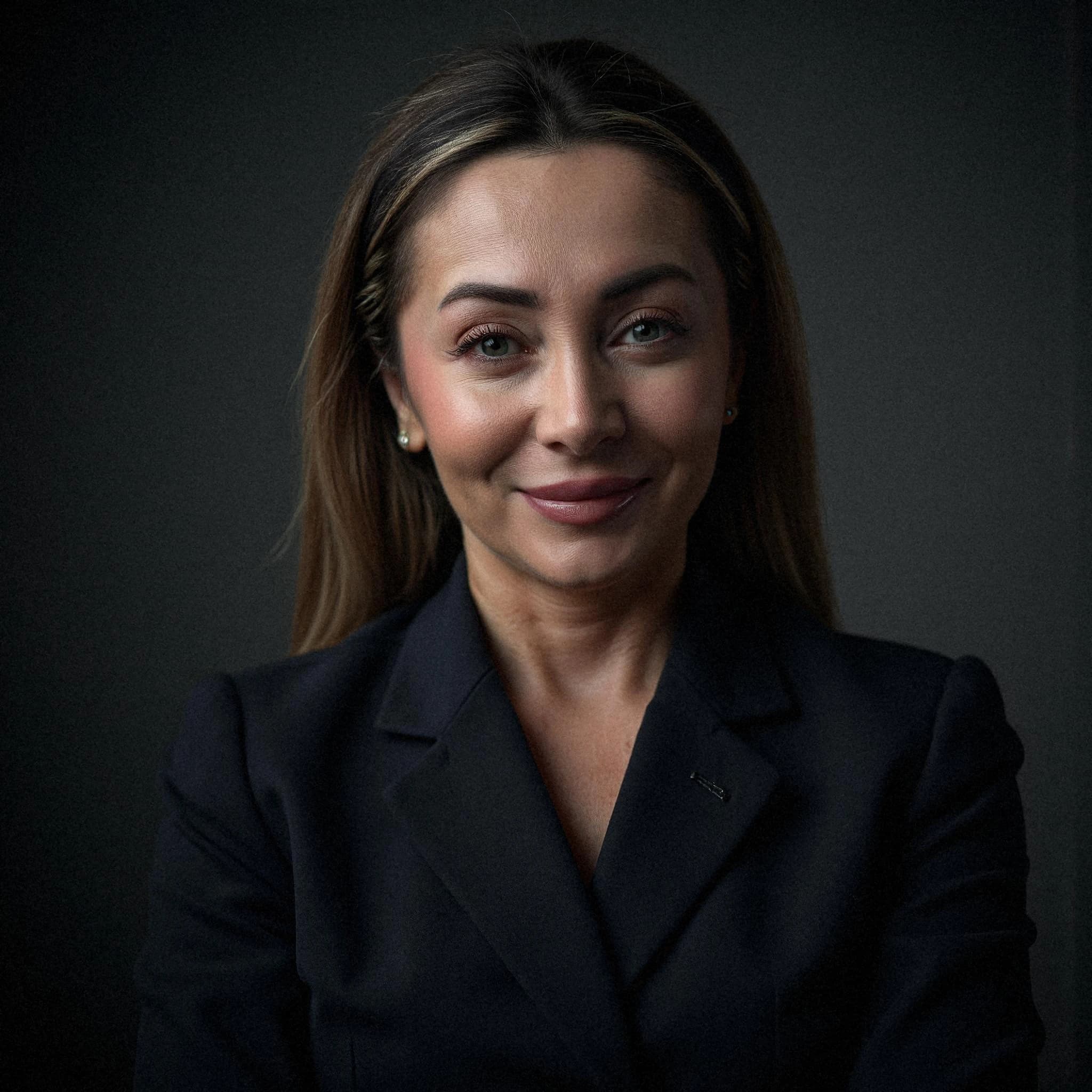 Professional headshot example: Woman Studio Black Suit Smiling 19 — LinkedInHeadshots.ai