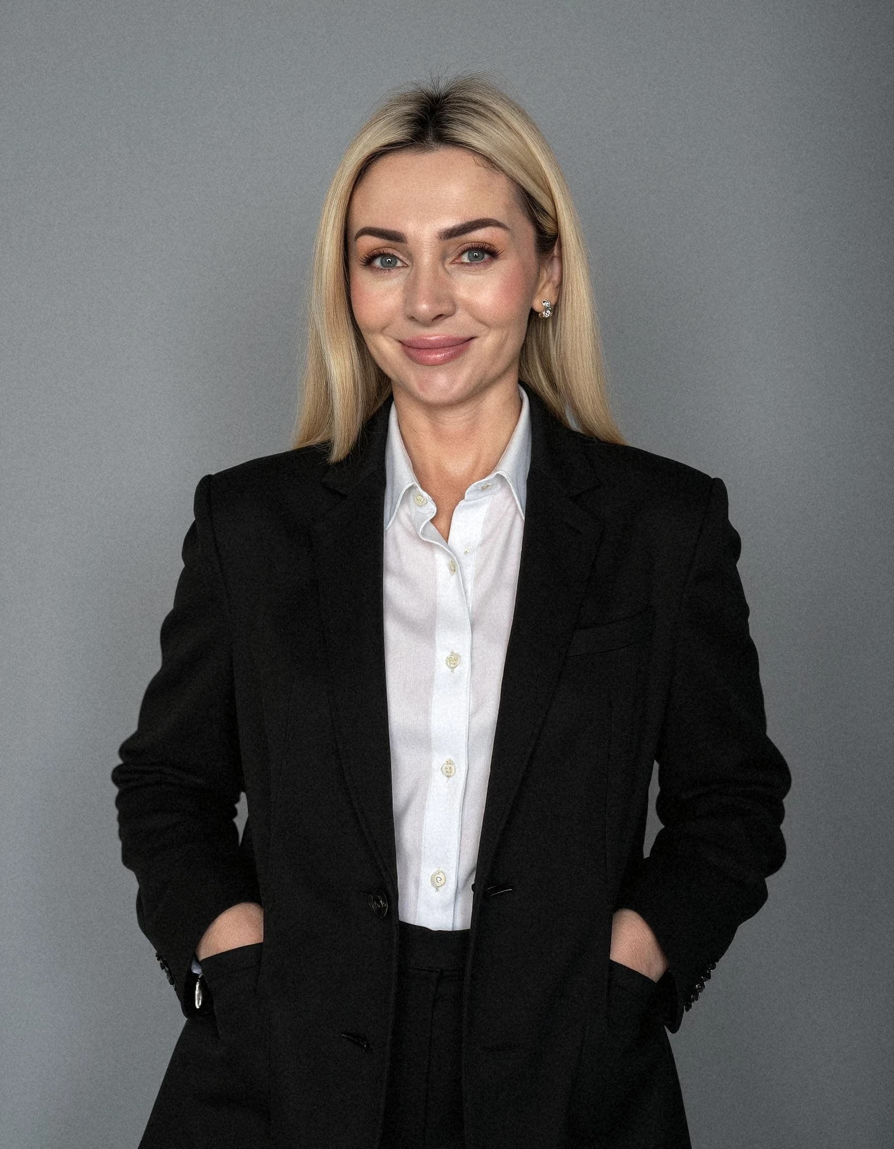 Professional headshot example: Woman Studio Black Suit Smiling 23 — LinkedInHeadshots.ai