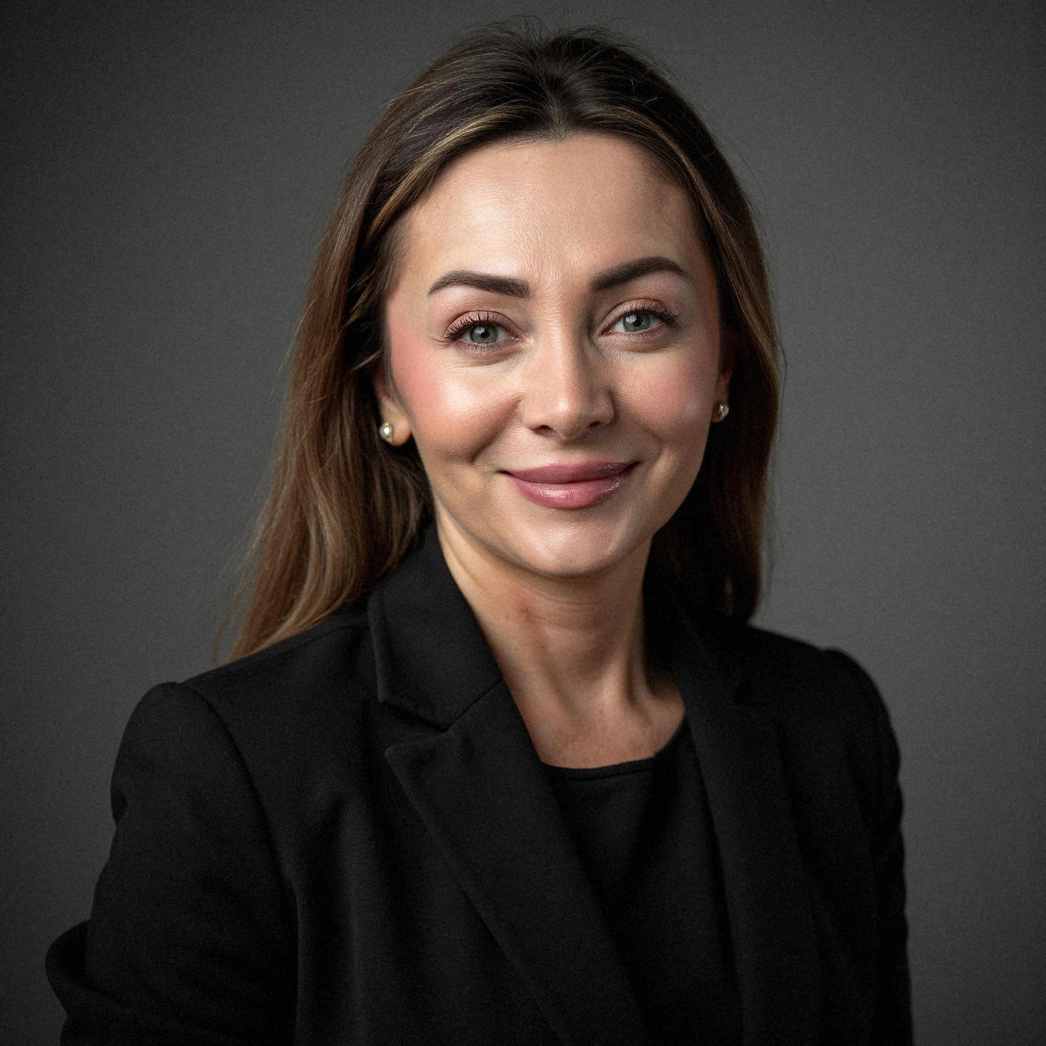 Professional headshot example: Woman Studio Black Suit Smiling 25 — LinkedInHeadshots.ai