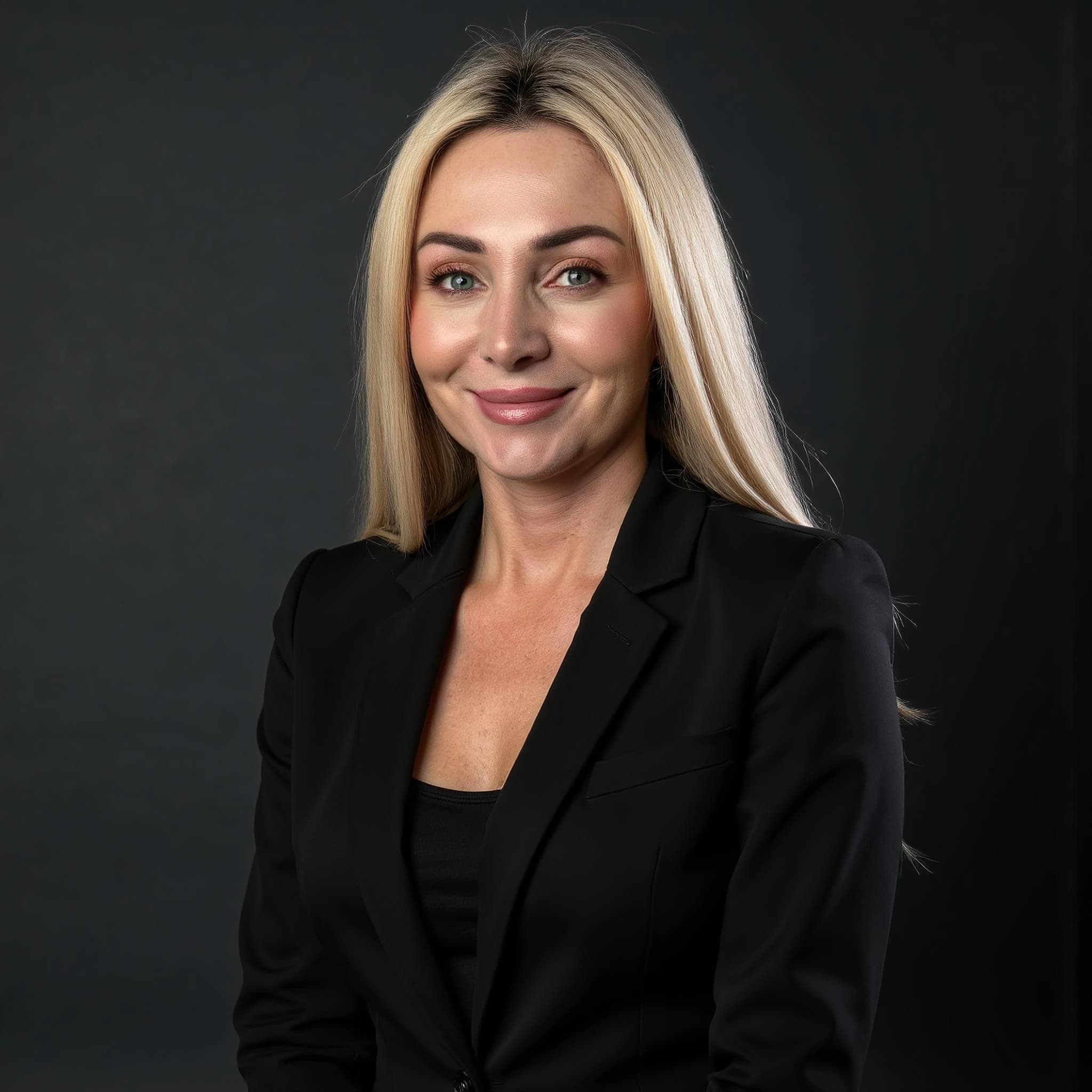 Professional headshot example: Woman Studio Black Suit Smiling 32 — LinkedInHeadshots.ai