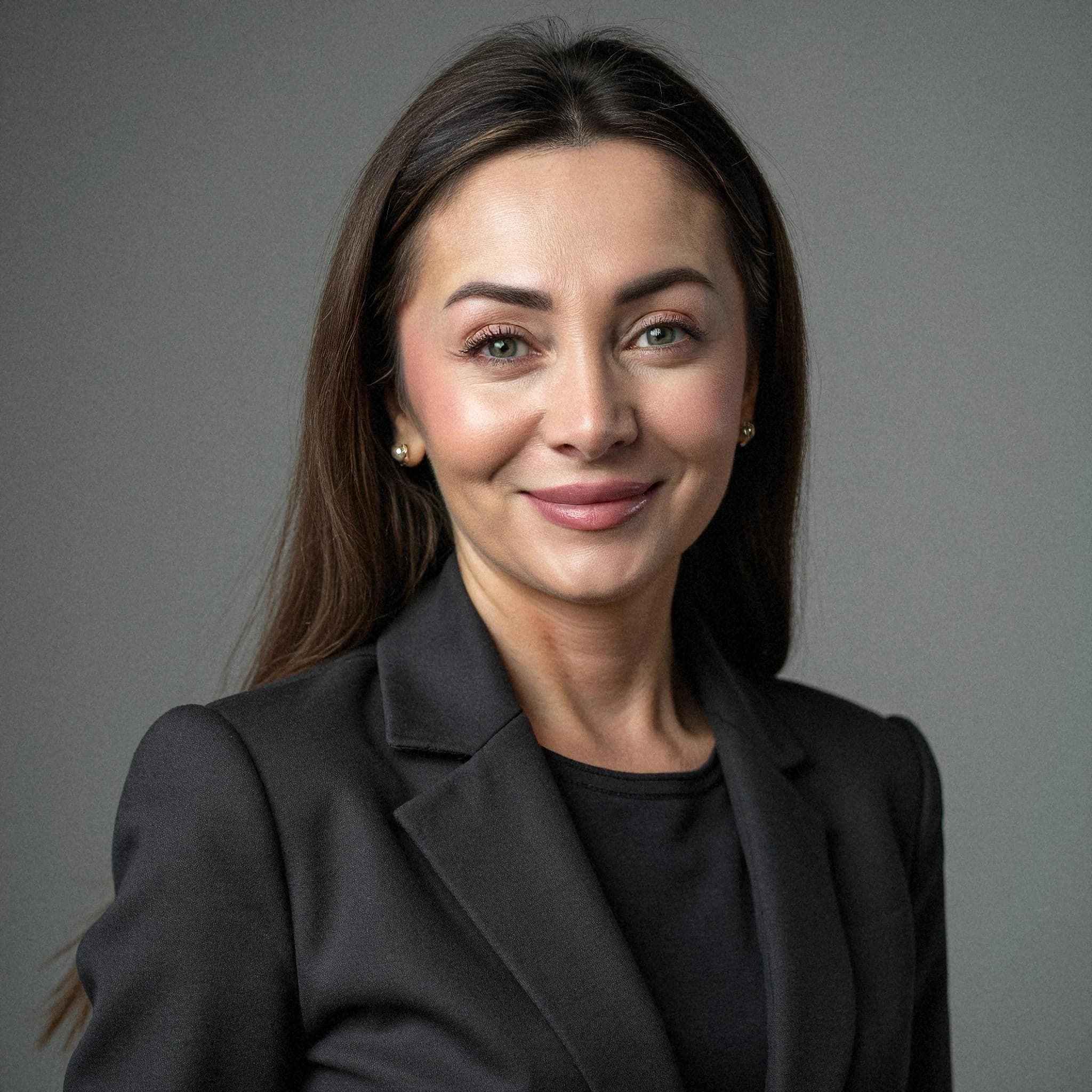 Professional headshot example: Woman Studio Black Suit Smiling 38 — LinkedInHeadshots.ai