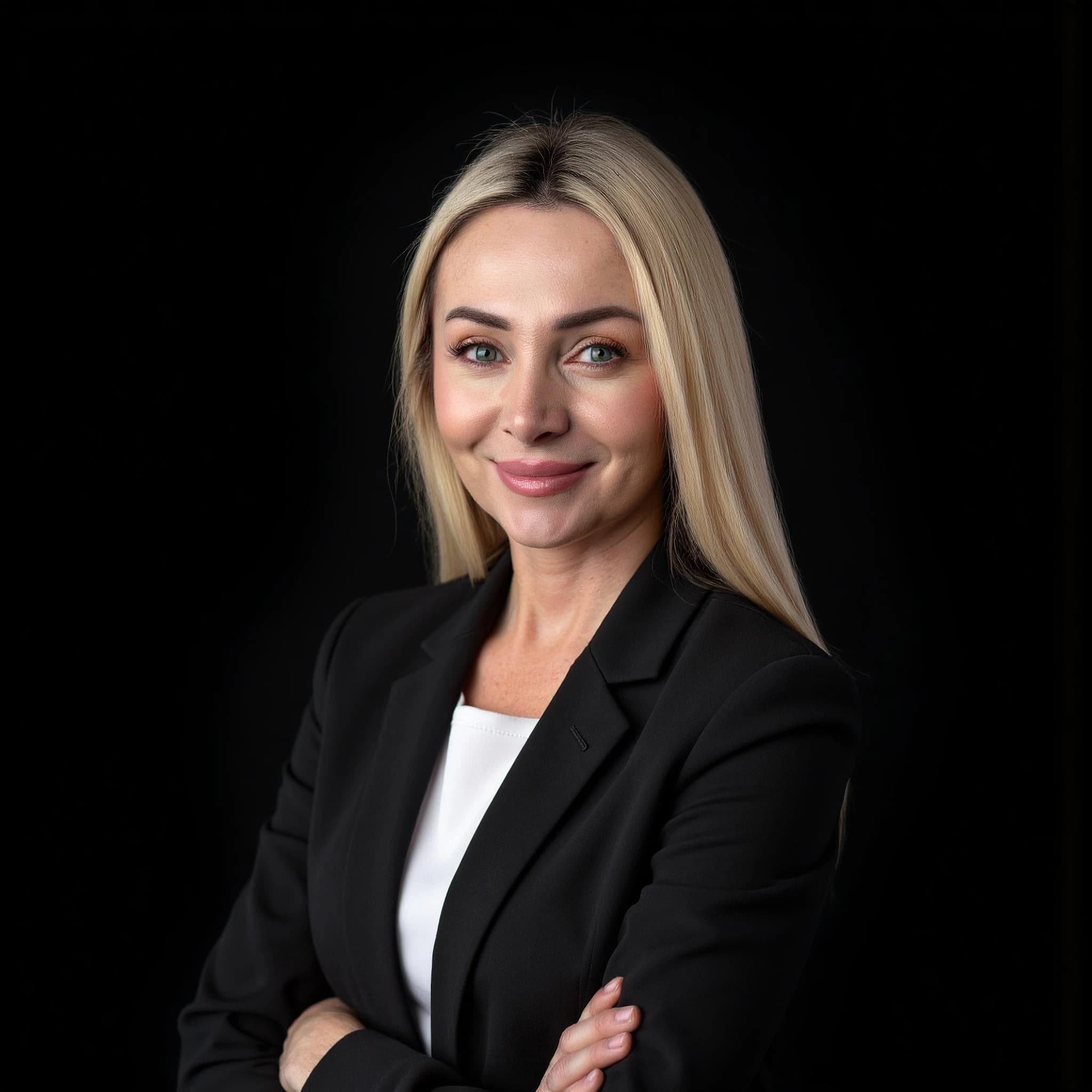 Professional headshot example: Woman Studio Black Suit Smiling 6 — LinkedInHeadshots.ai