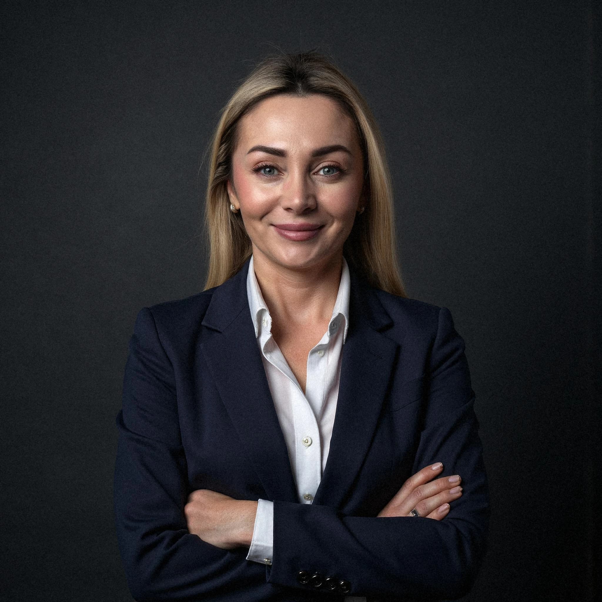 Professional headshot example: Woman Studio Navy Suit Crossed Arms — LinkedInHeadshots.ai