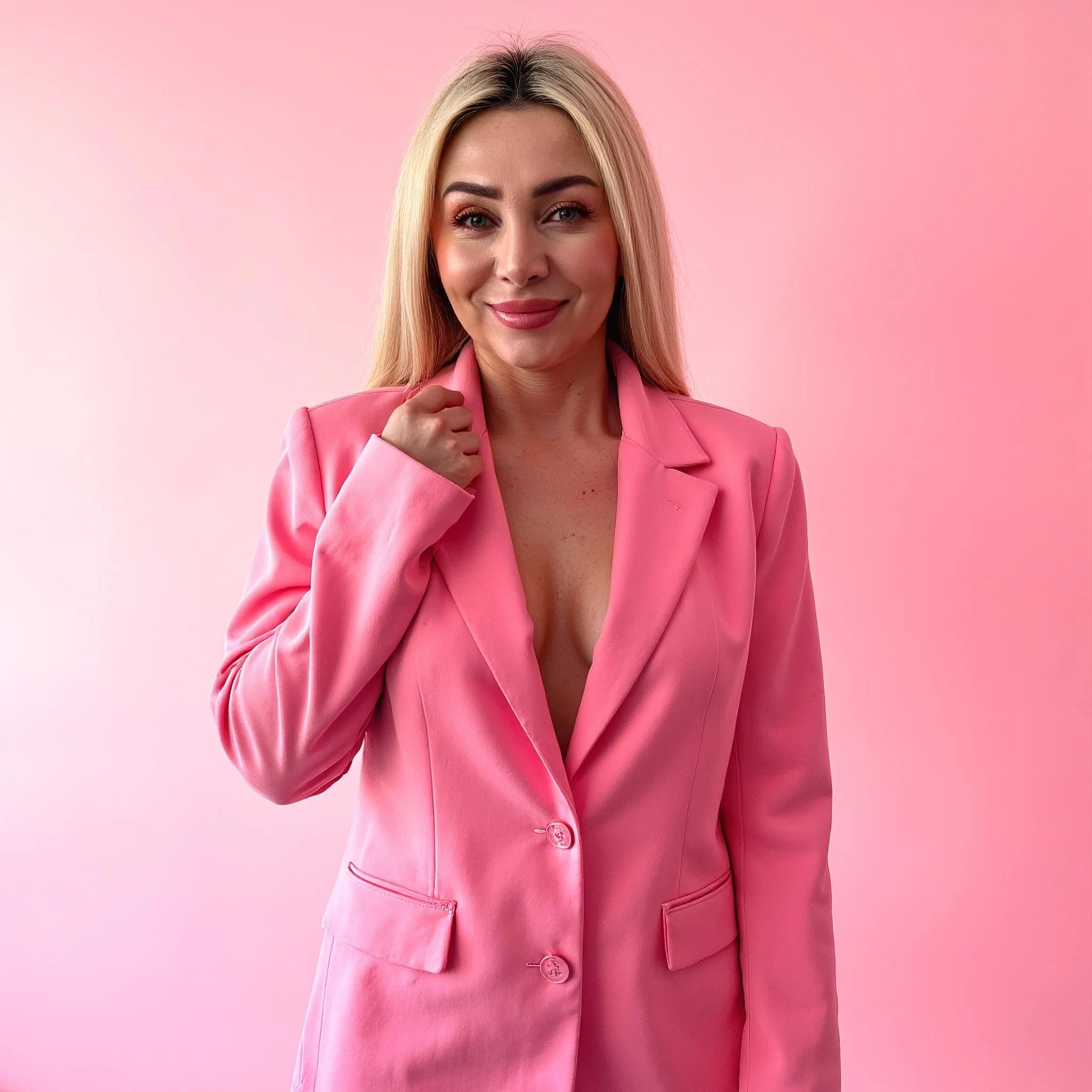 Professional headshot example: Woman Studio Pink Suit Smiling — LinkedInHeadshots.ai