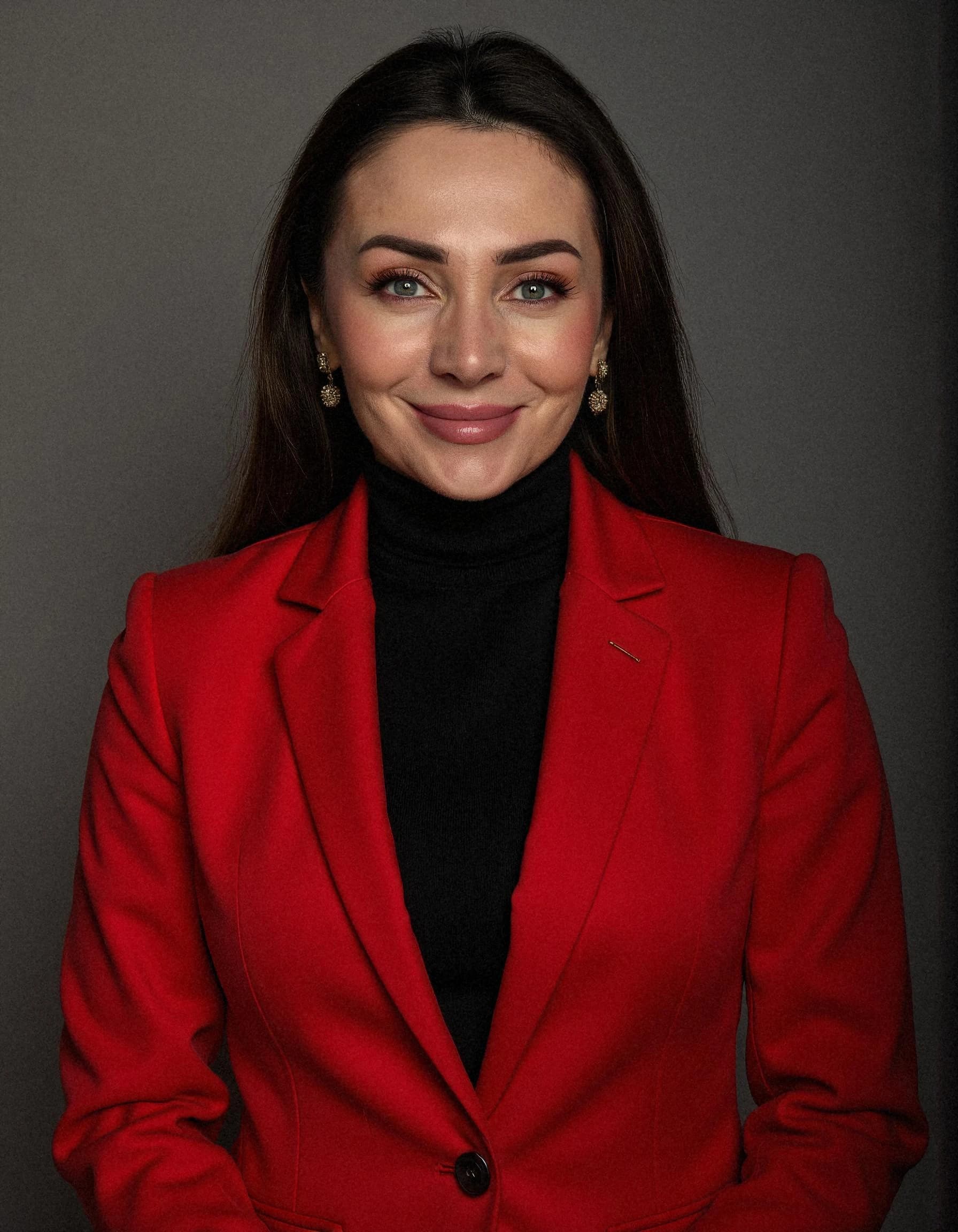 Professional headshot example: Woman Studio Red Blazer Smiling — LinkedInHeadshots.ai