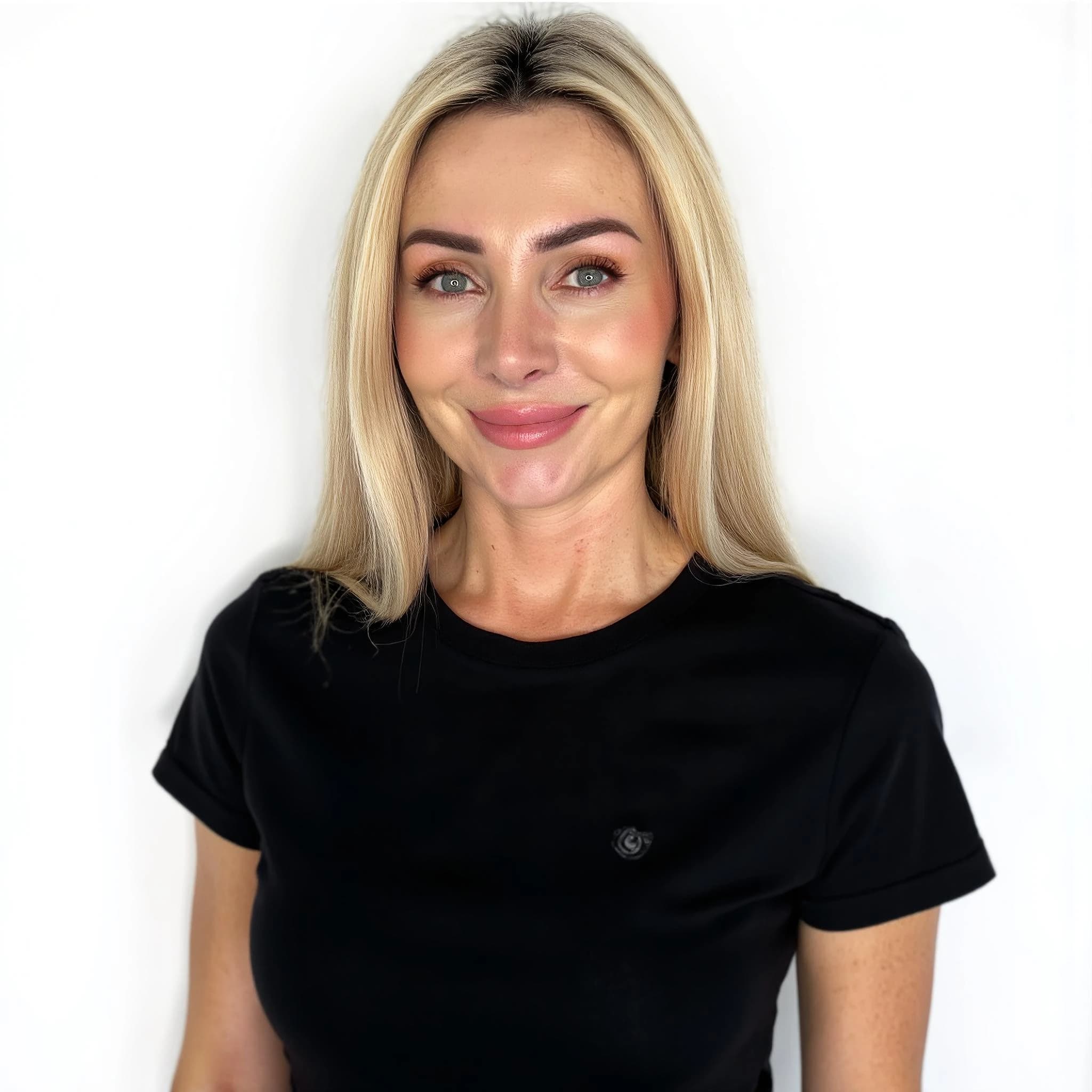 Professional headshot example: Woman White Background Black Shirt Smiling — LinkedInHeadshots.ai