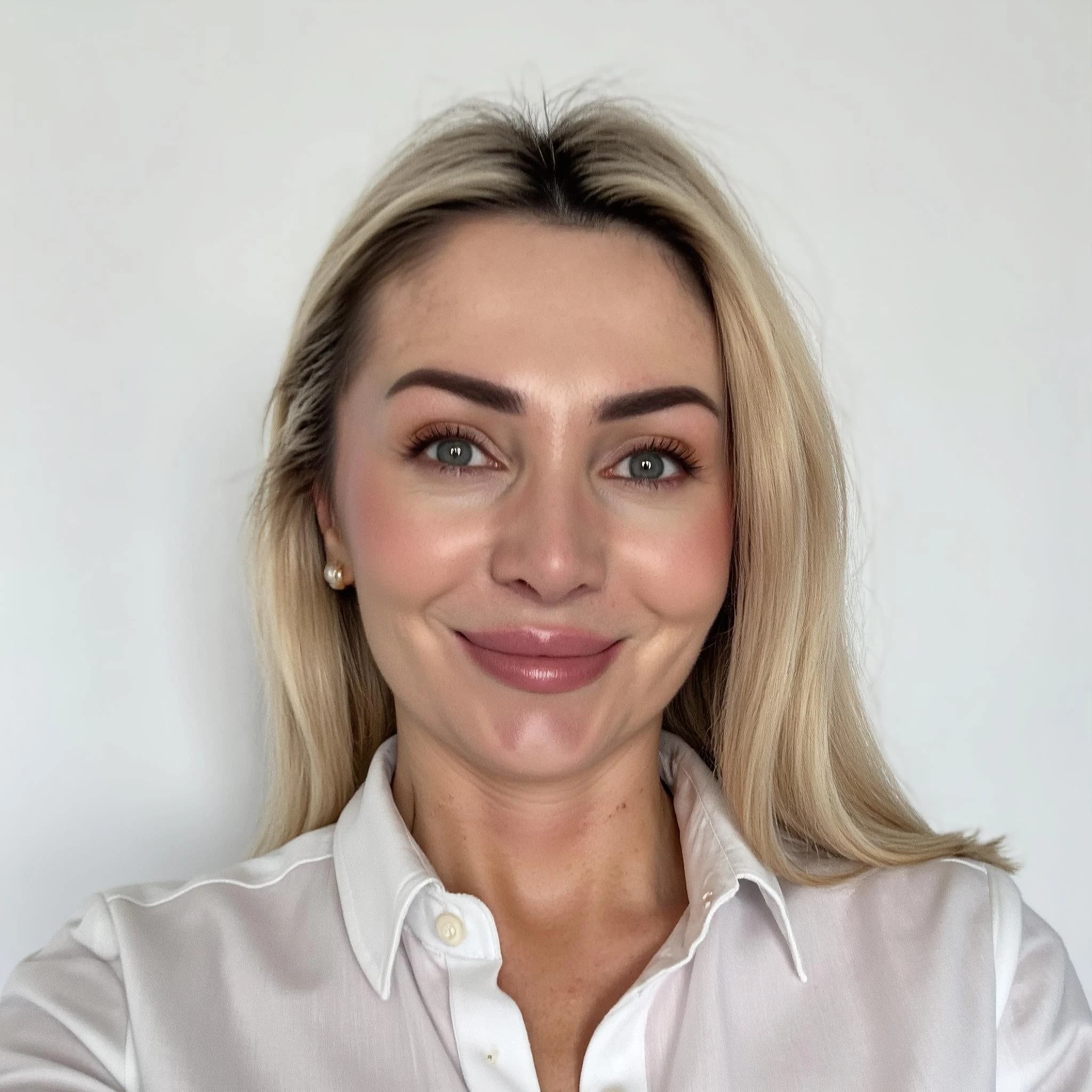 Professional headshot example: Woman White Background White Shirt Smiling — LinkedInHeadshots.ai